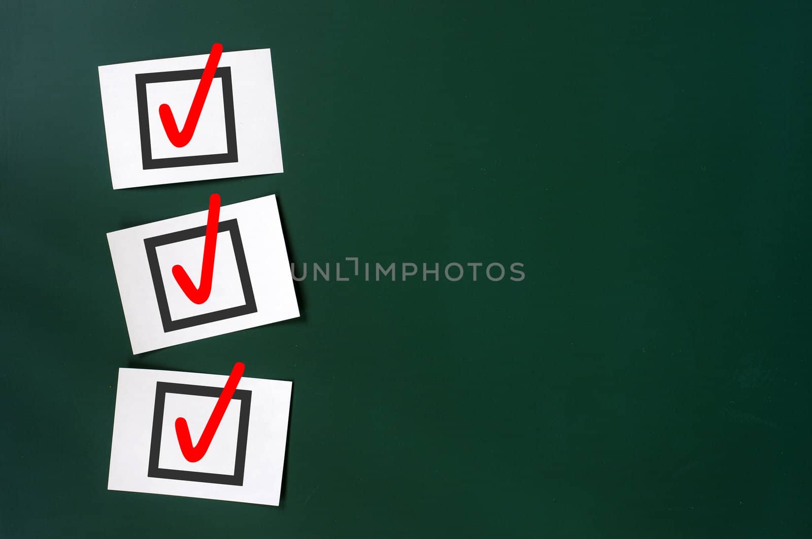 Check box with red tick on a green chalkboard, with copy space for text