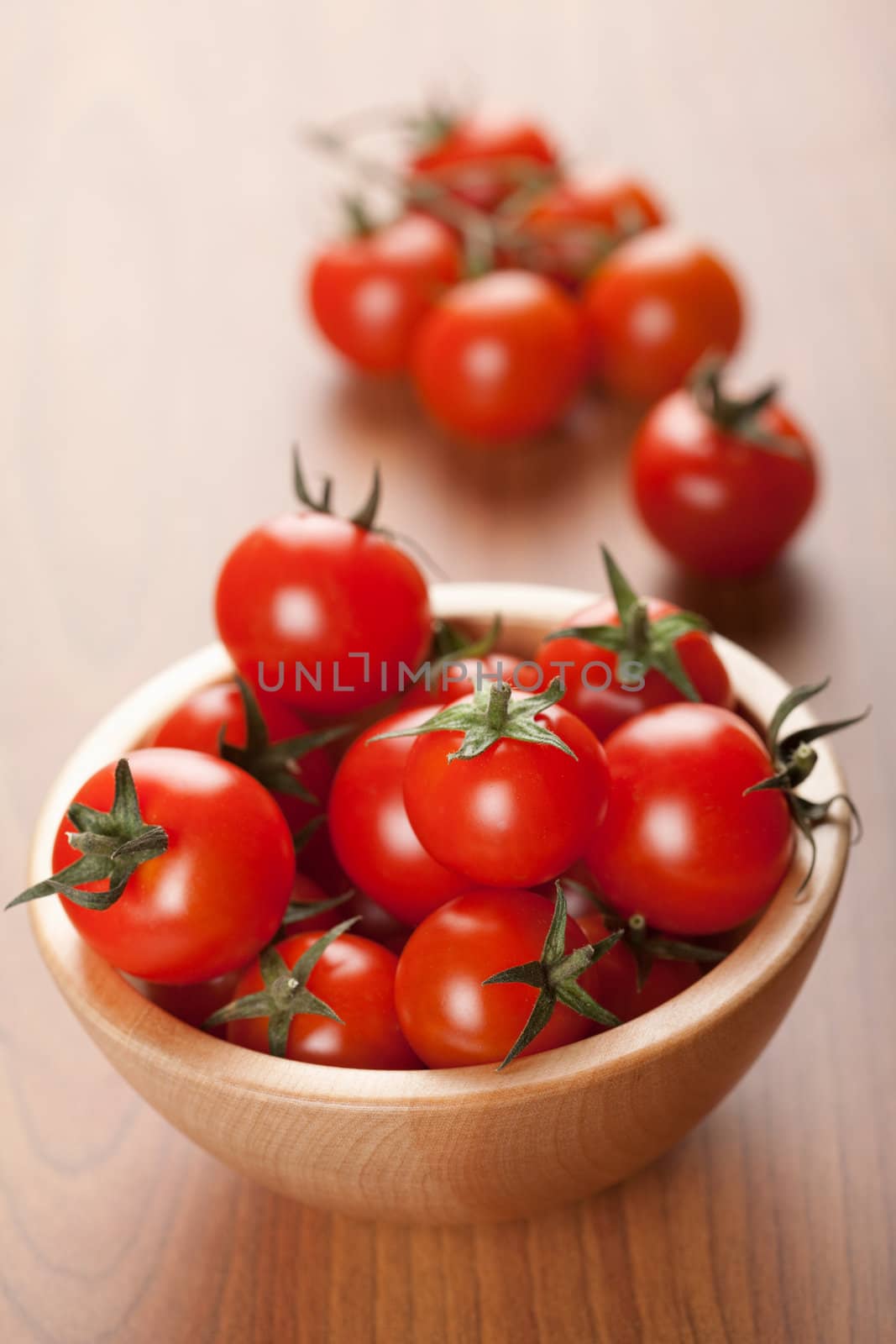 ripe tomatoes in wooden bowl
