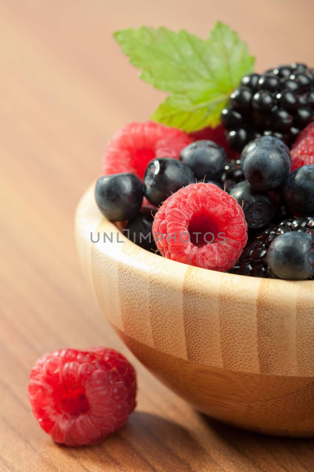 fresh berries in wood bowl 