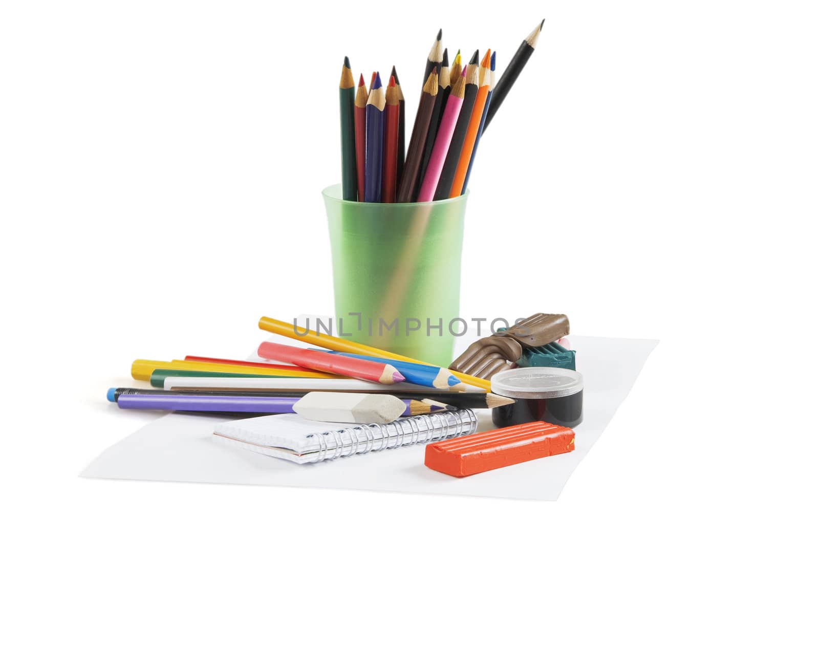 Multi-colored pencils in a glass on a white background