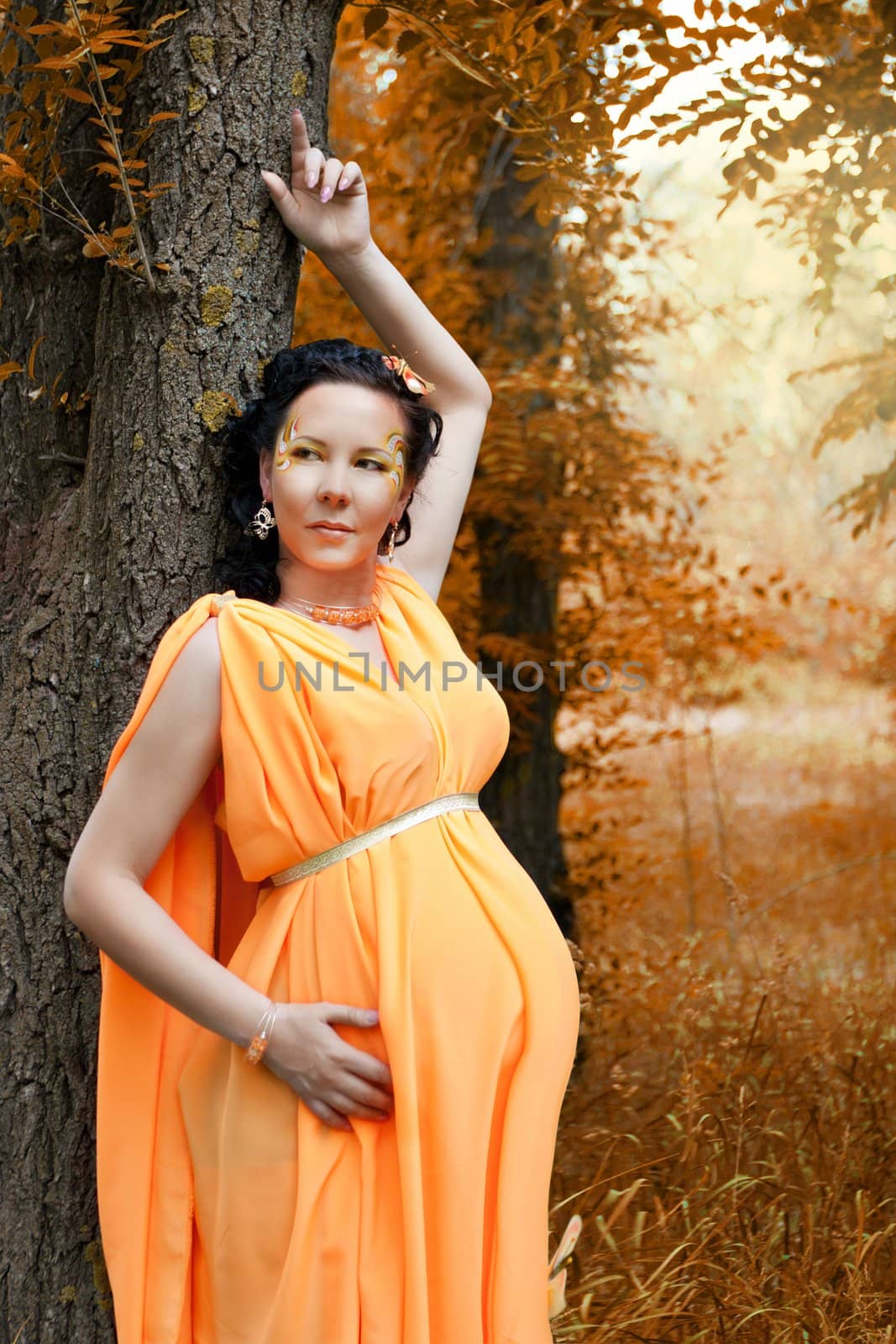 pregnant woman standing near tree by nigerfoxy