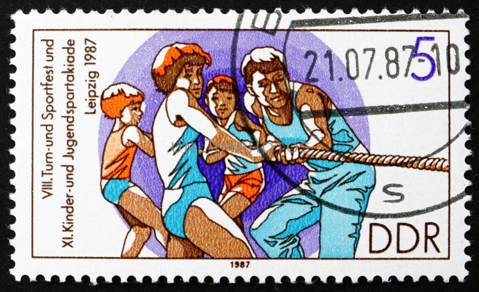 GDR - CIRCA 1987: a stamp printed in GDR shows Tug of War, 11th Children�s and Youths� Spartakiade, circa 1987