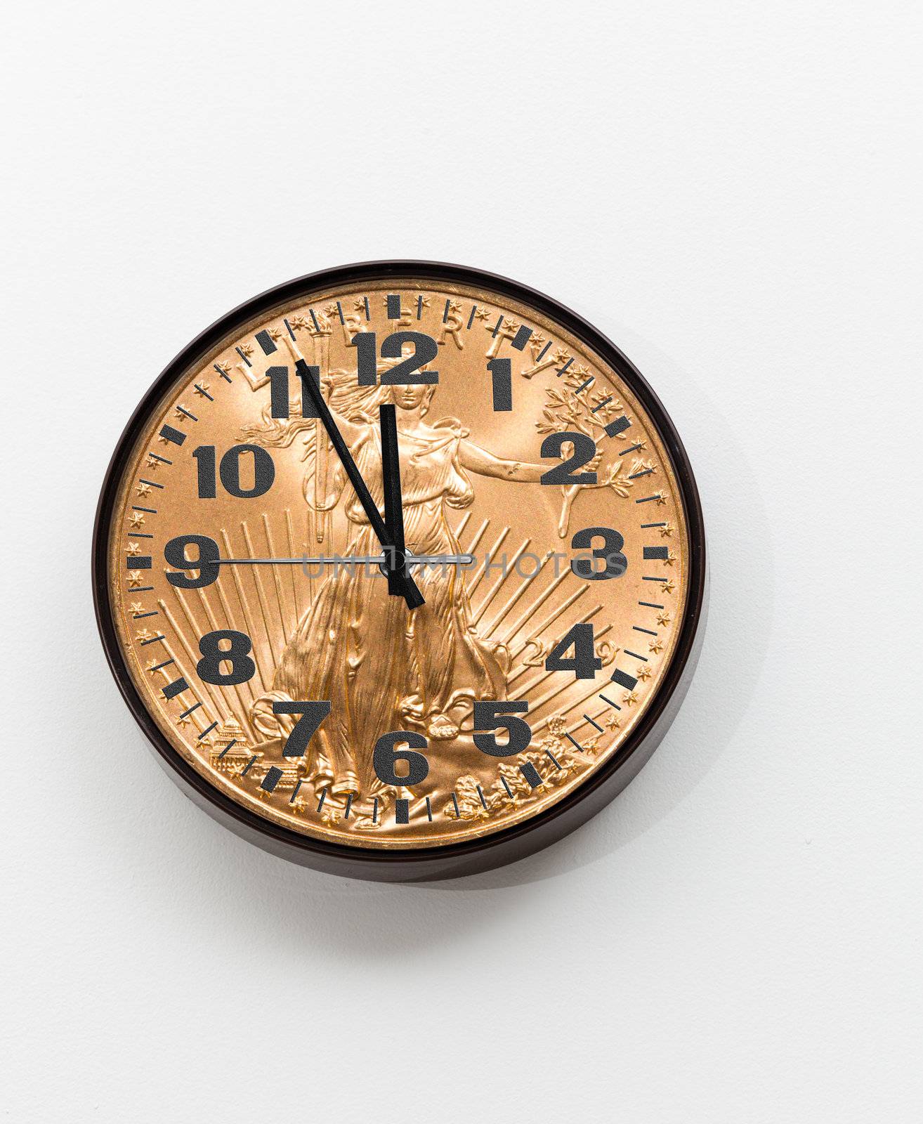 Concept of time is money from a wall clock close to midnight made from gold coin