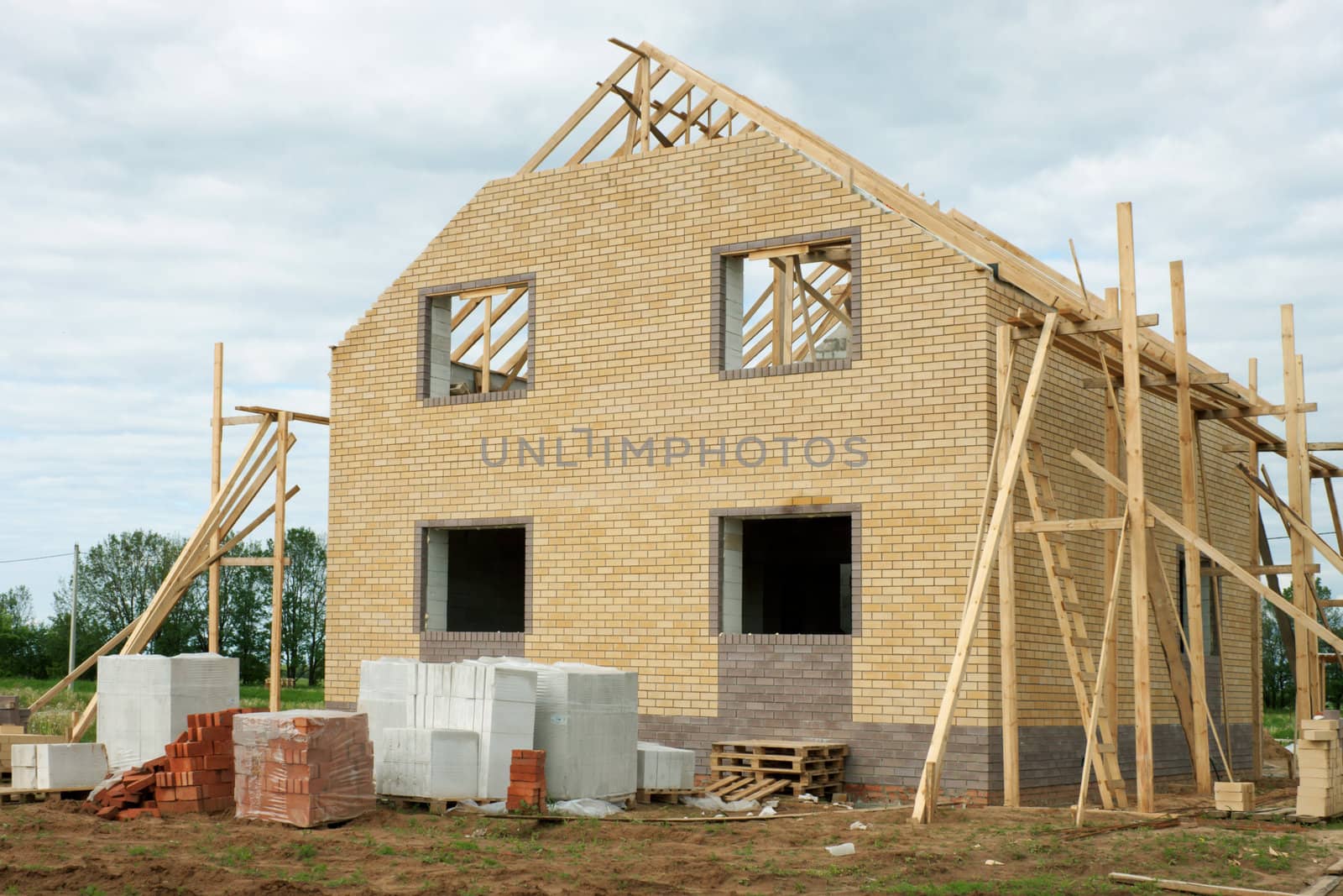 Country house of yellow brick in the construction phase
