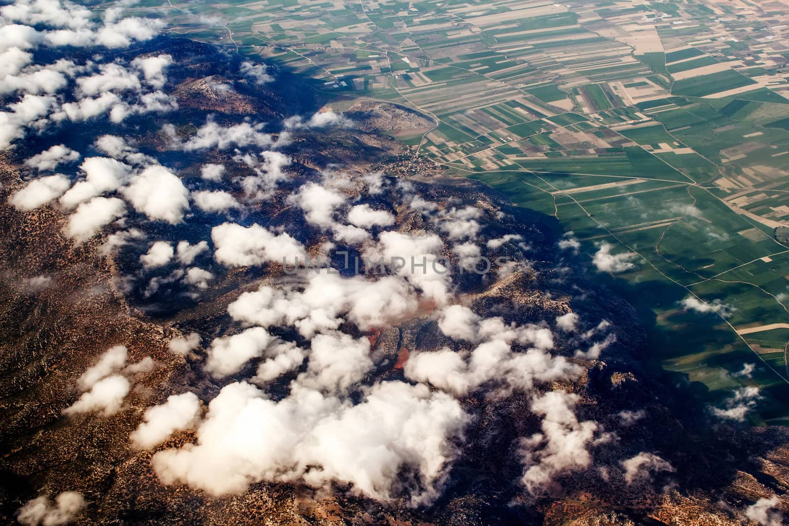 view of the mountains from an airplane above the clouds