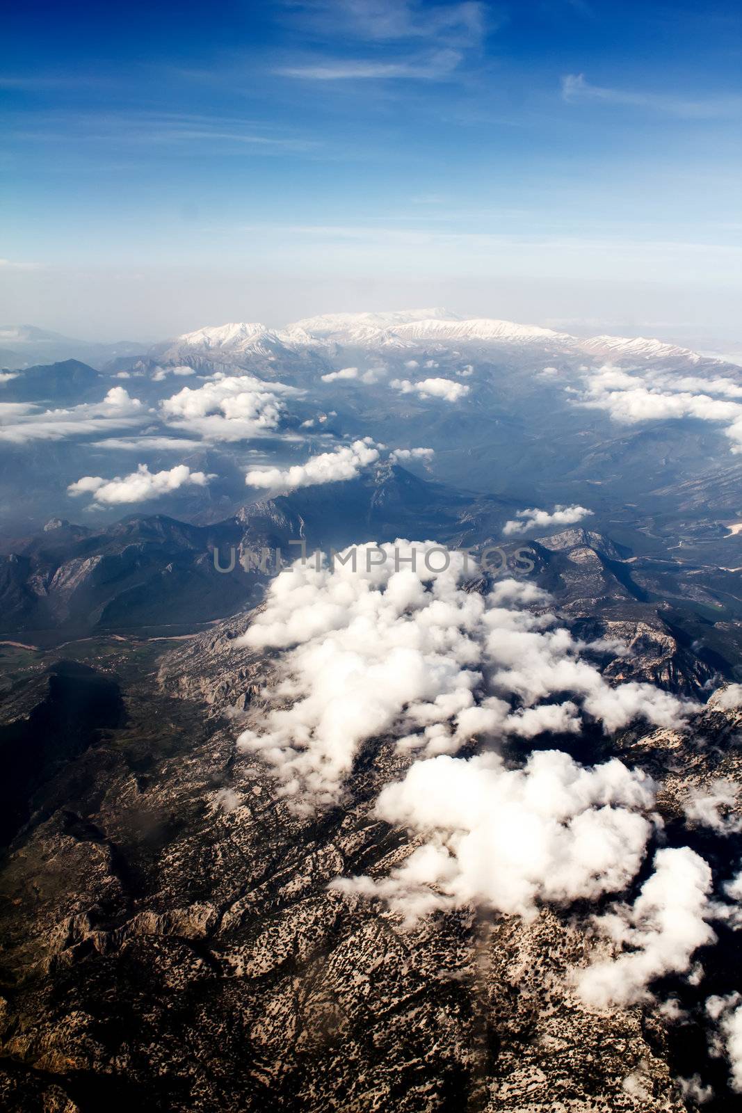 view of the mountains from an airplane above the clouds