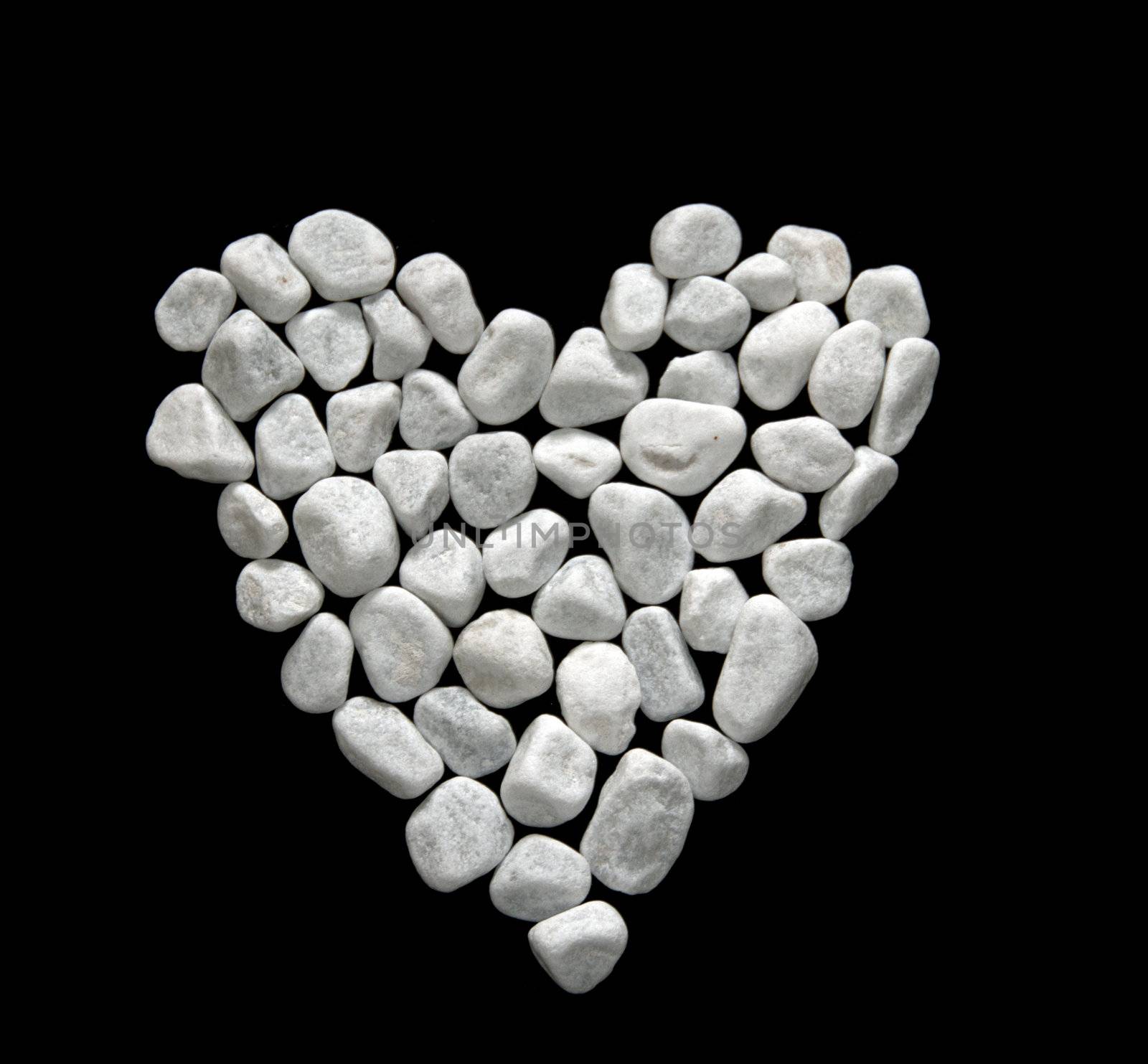 white stones on black background make the heart