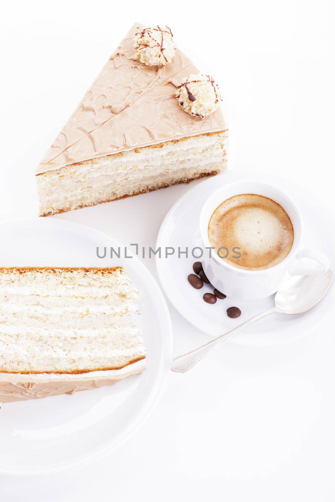 hazelnut cream cake from top with a cup of coffee on white background
