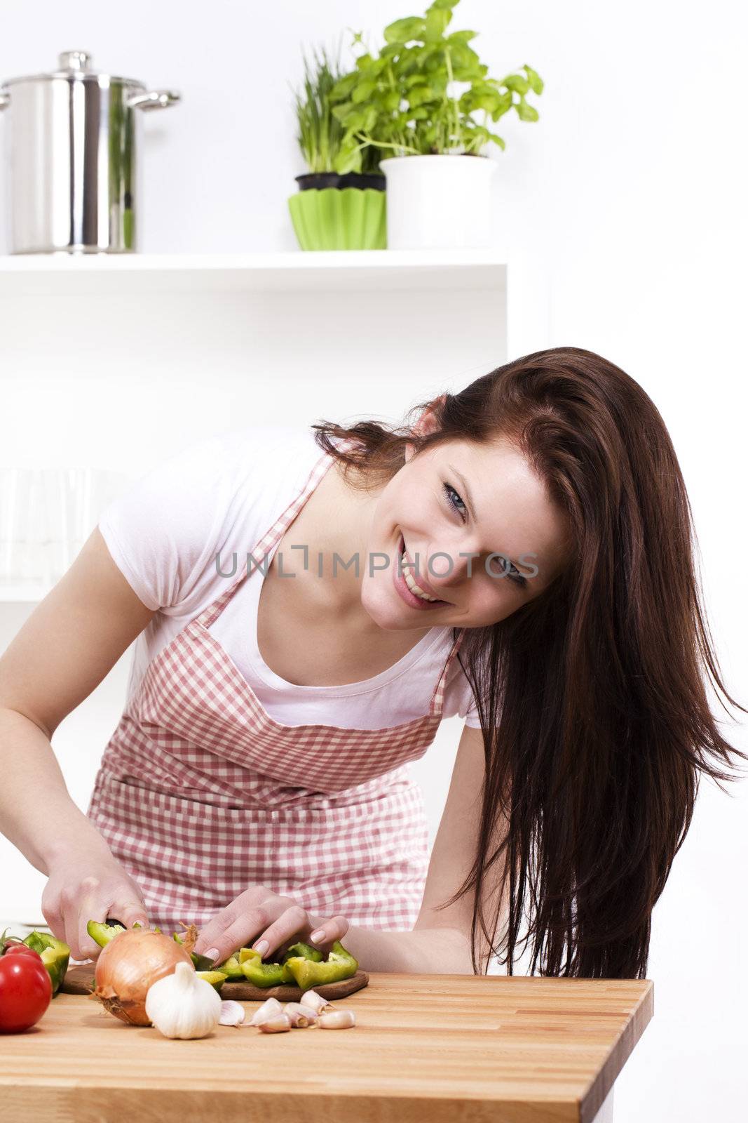 woman in kitchen cutting paprika by RobStark