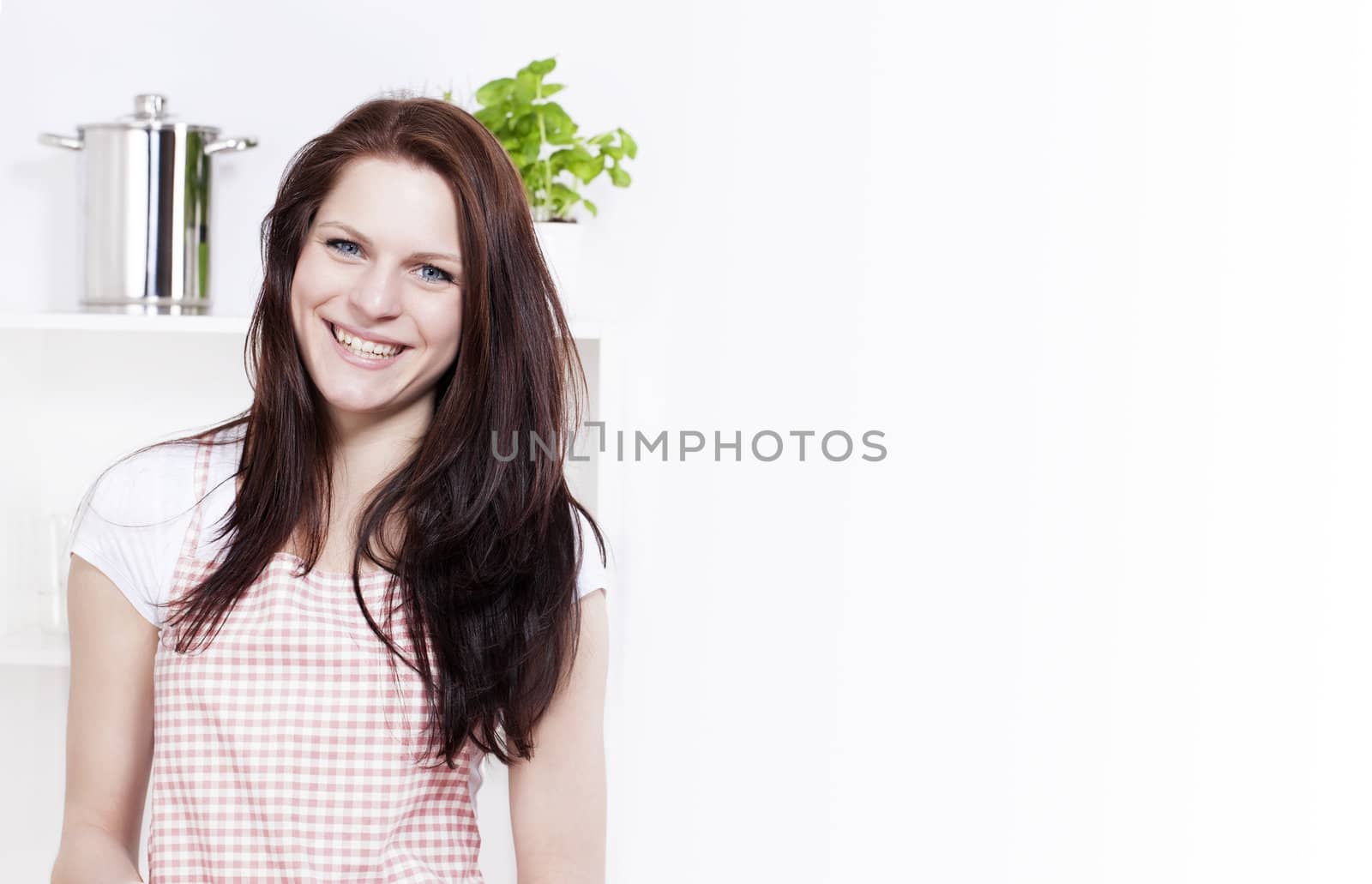 happy smiling young woman in a kitchen