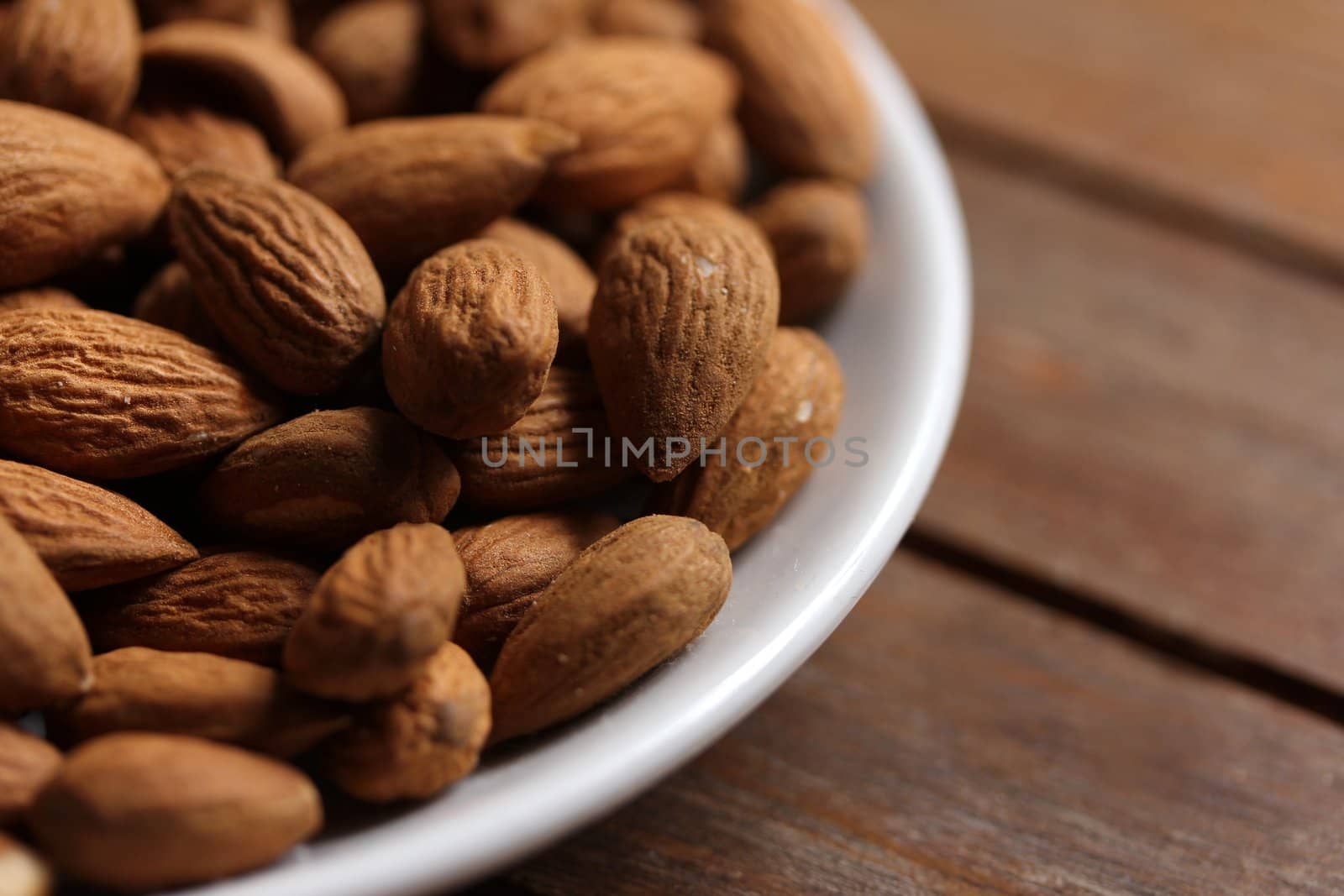 almonds in a white plate by Teka77