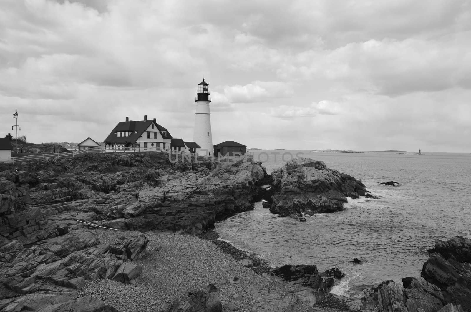 Famous portland head light off the coast of maine shown in black and white.
