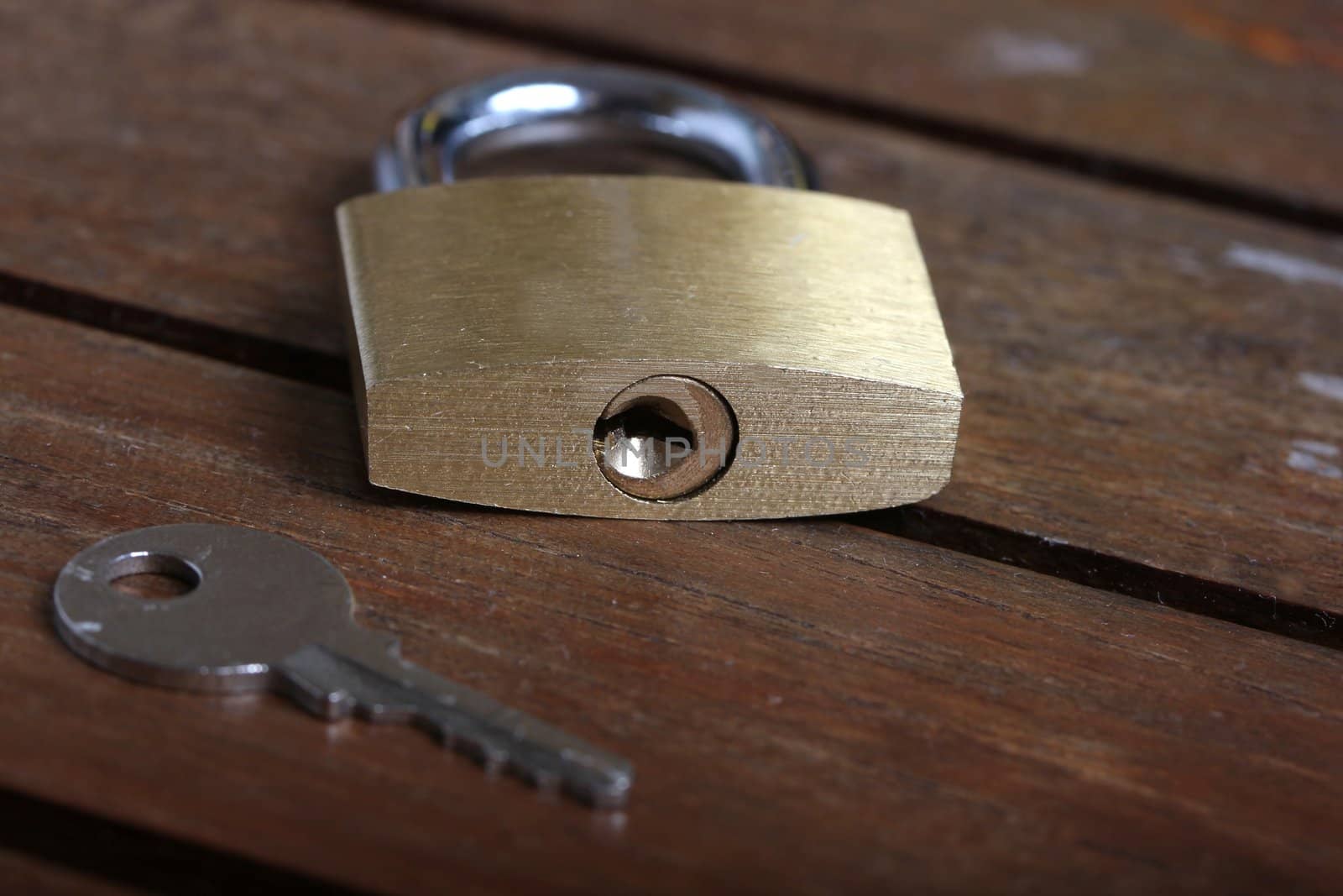 padlock with key on wooden background