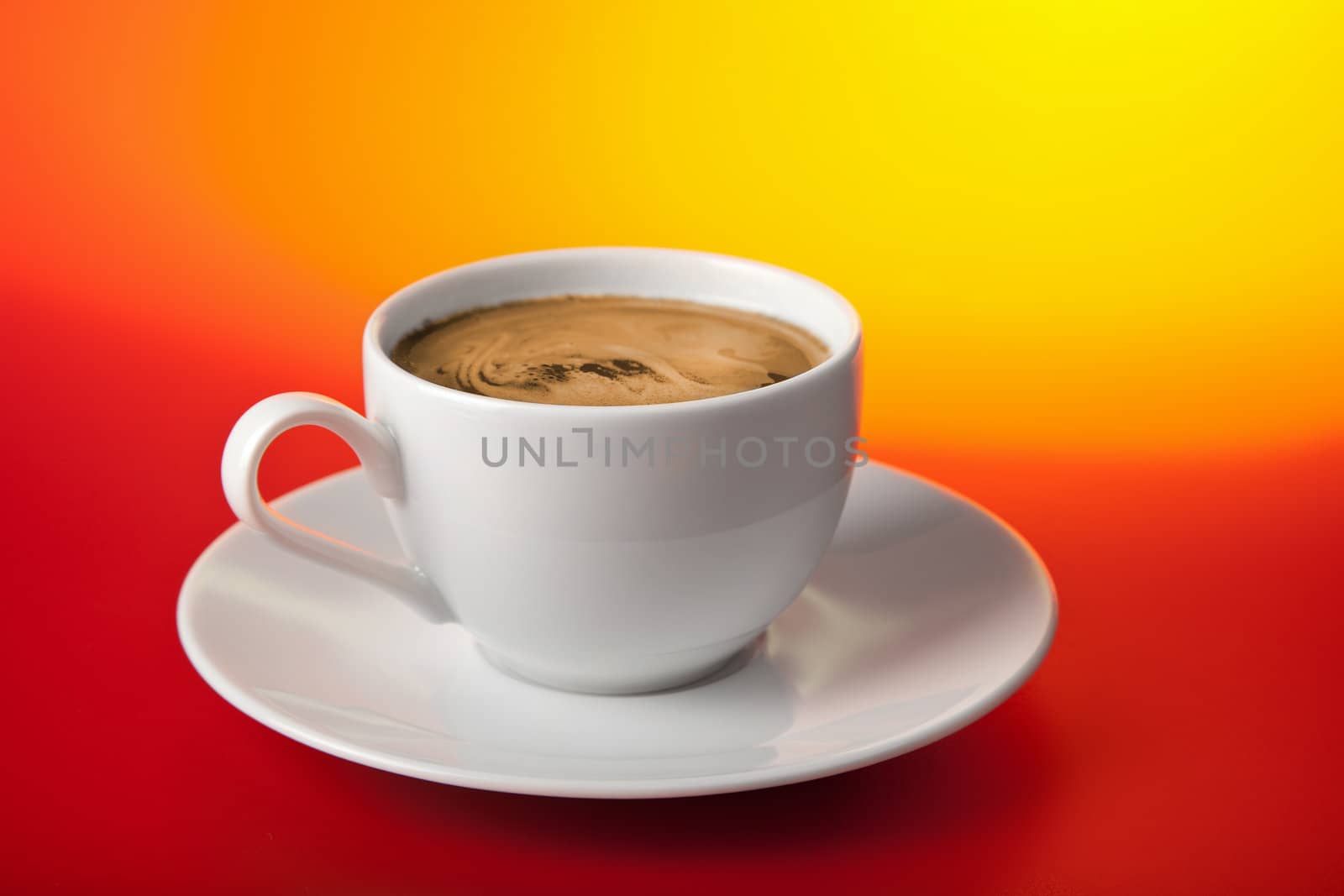 cup of coffee over red and yellow background