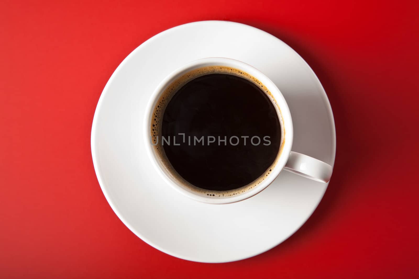cup of coffee over red background