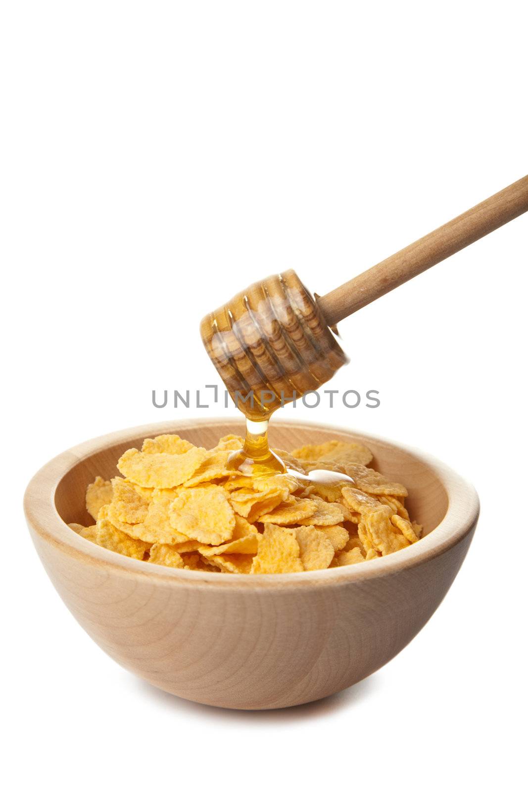 honey pouring over cornflakes isolated