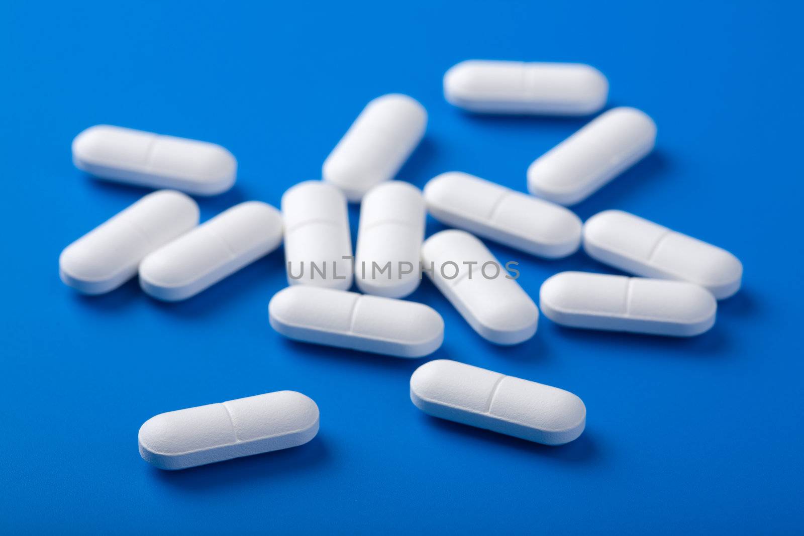white pills over blue