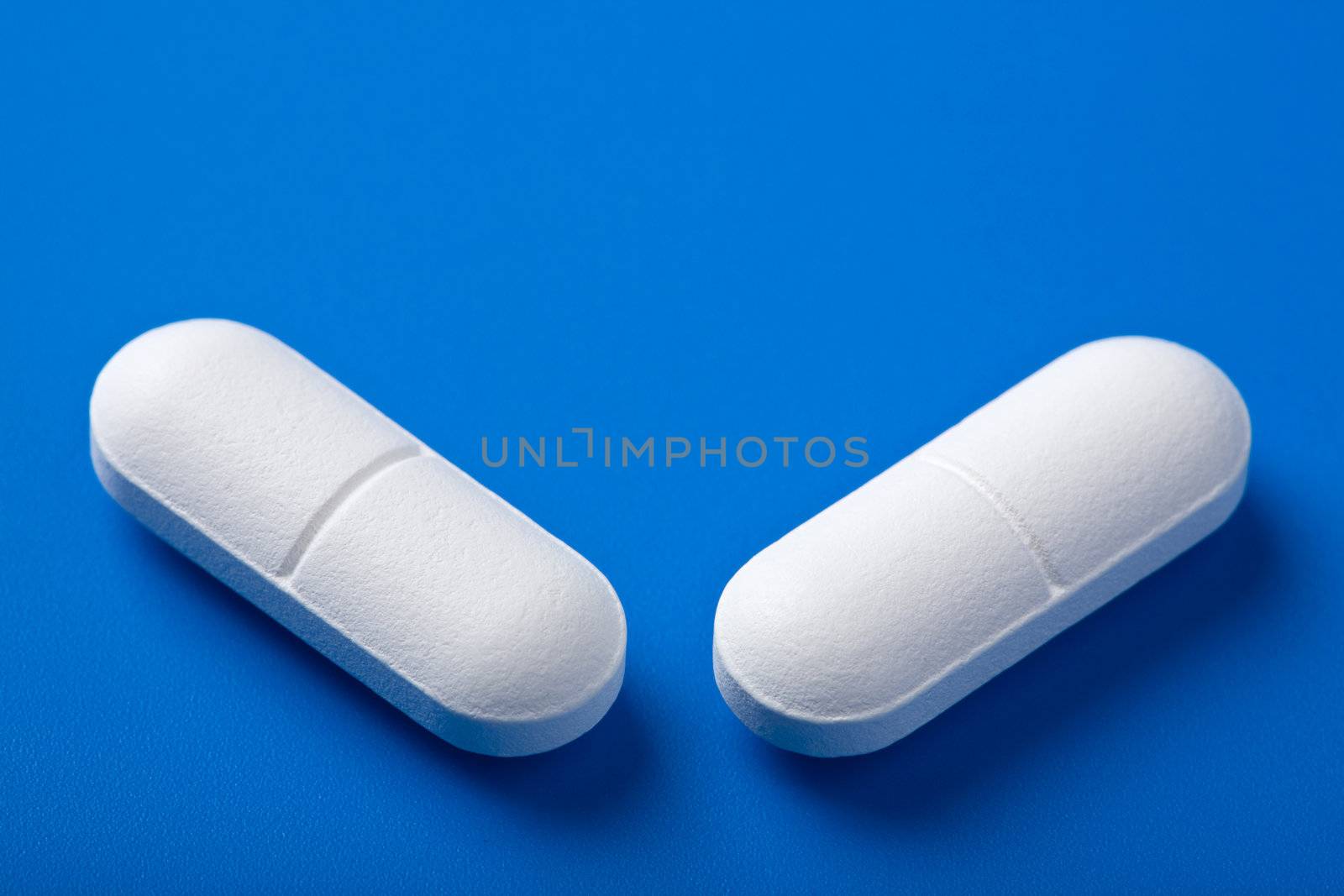 white pills over blue
