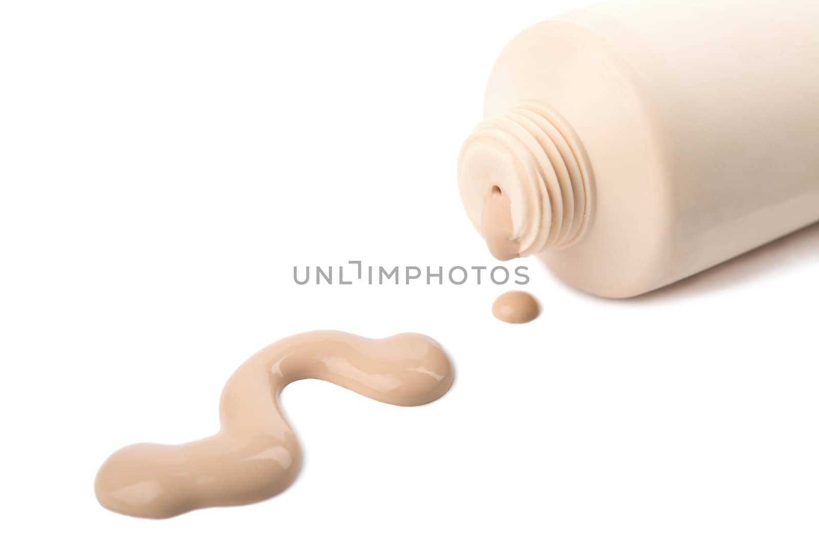 liquid foundation spilled out of bottle isolated
