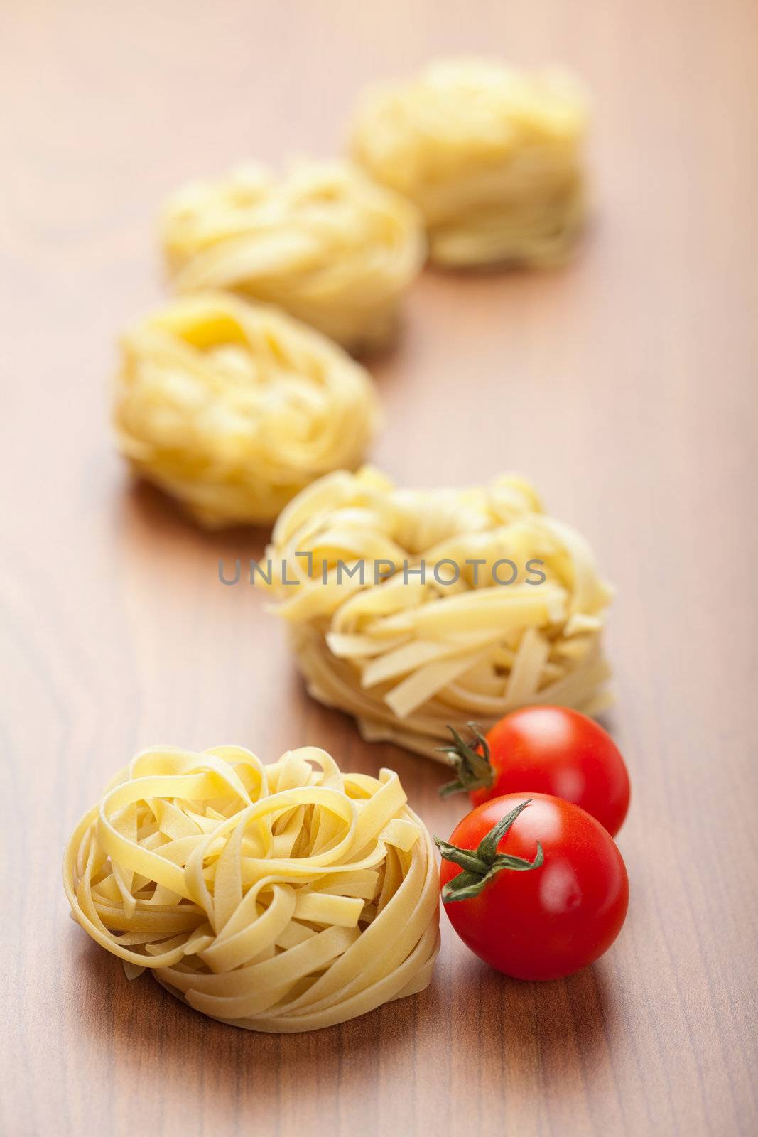 raw pasta tagliatelle and tomatoes