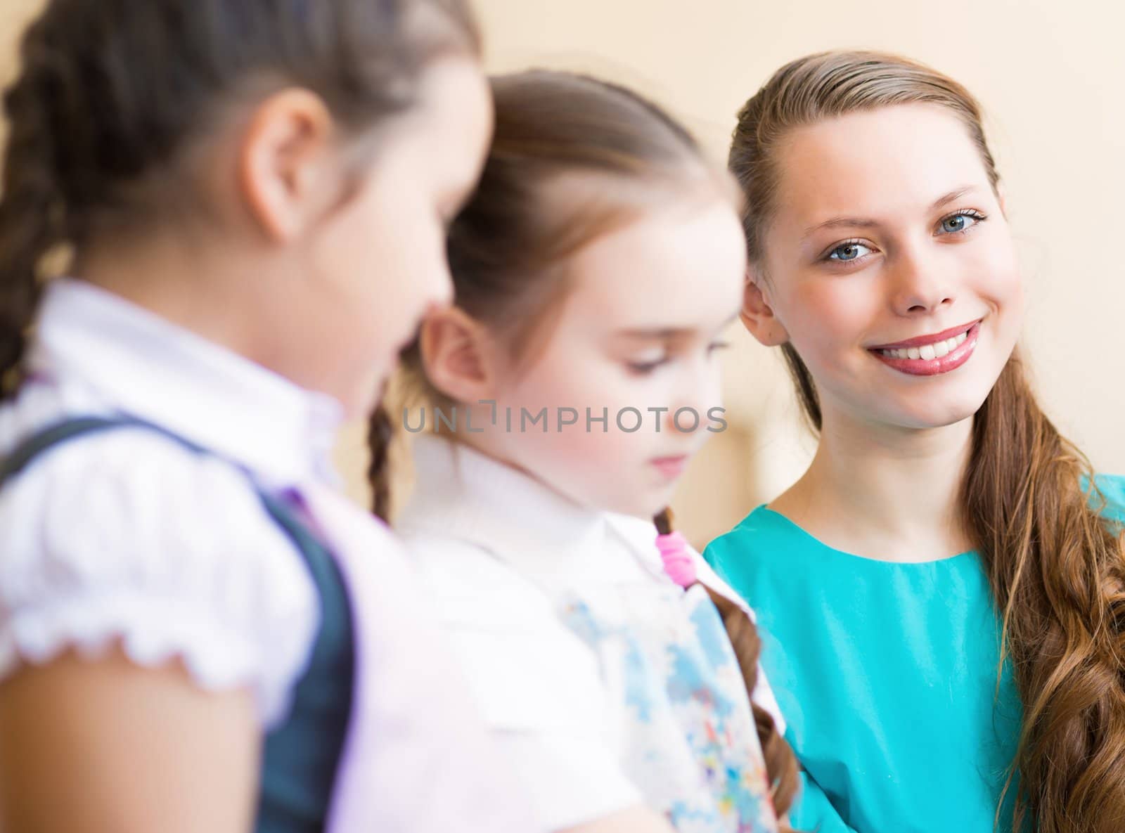 children draw with the teacher in the classroom drawing