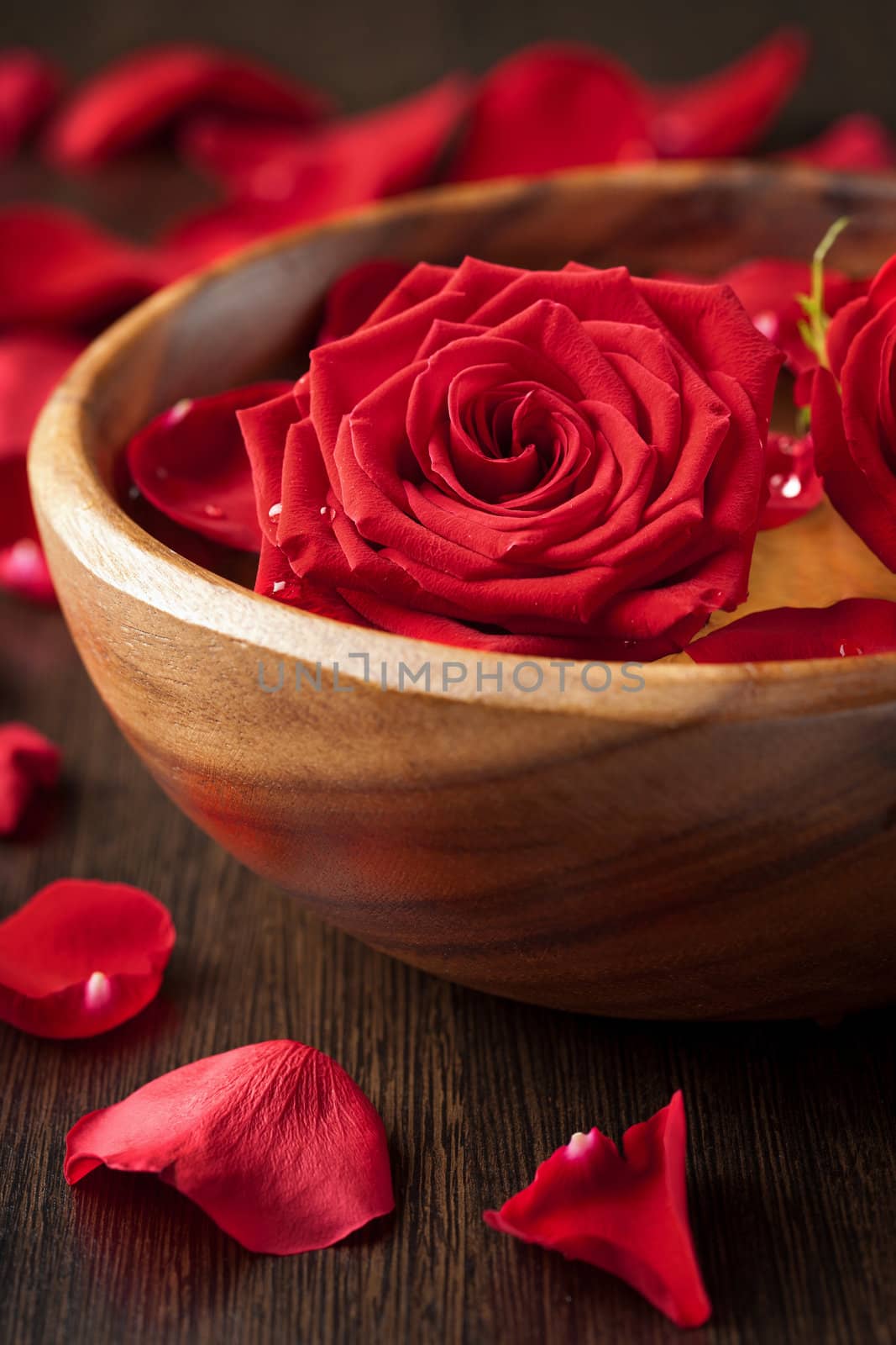 red roses in wooden bowl 