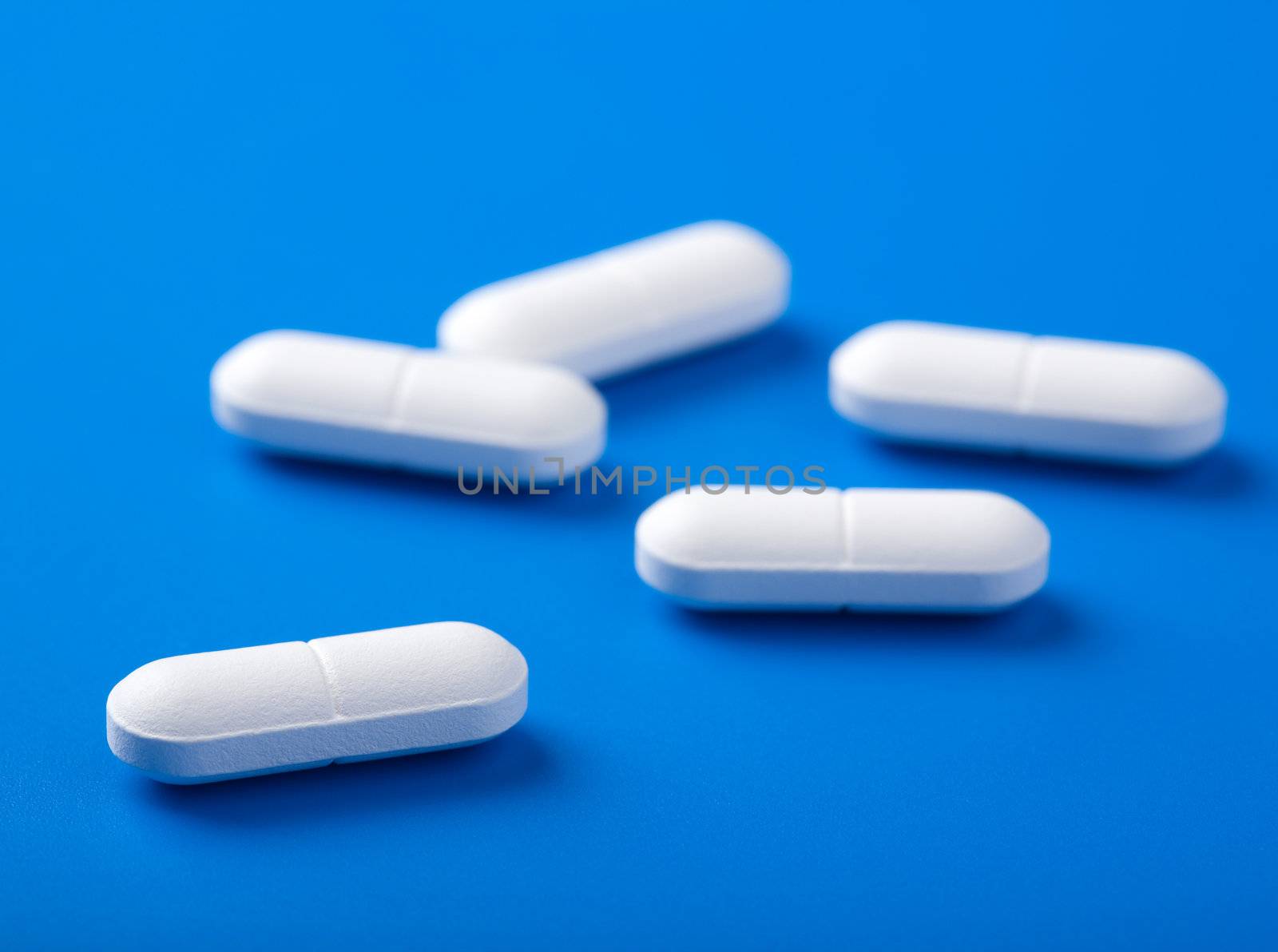 white pills over blue