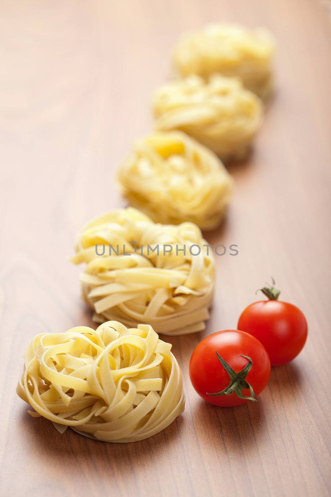 raw pasta tagliatelle and tomatoes 