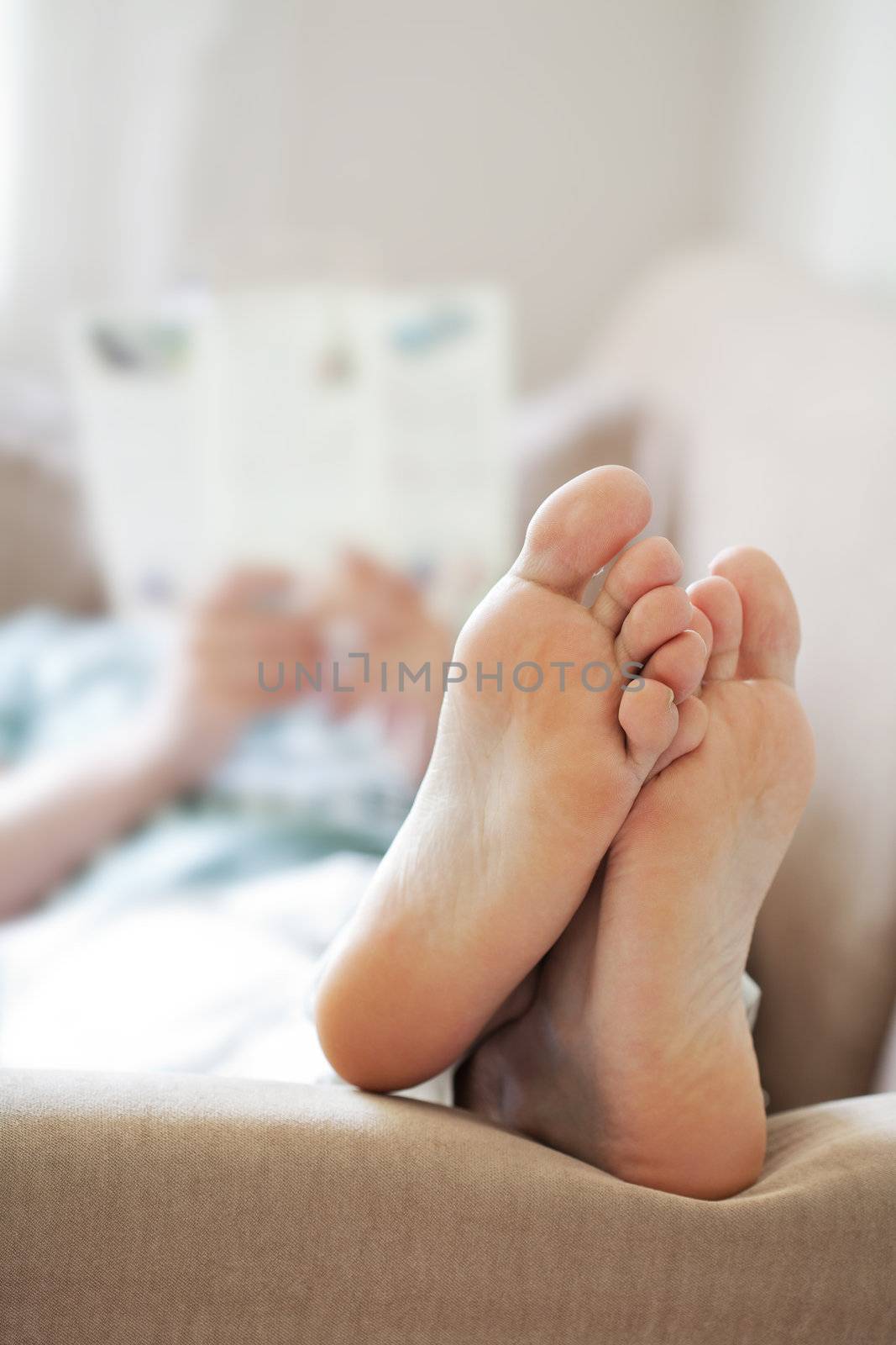 man relaxing on sofa. focus on feet