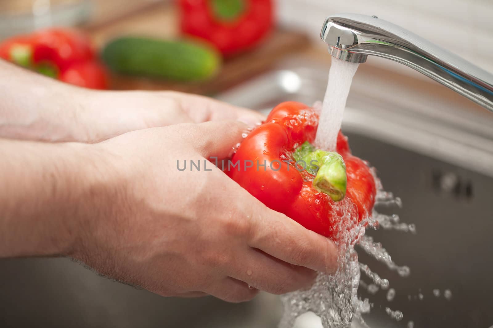 man washing vegetable