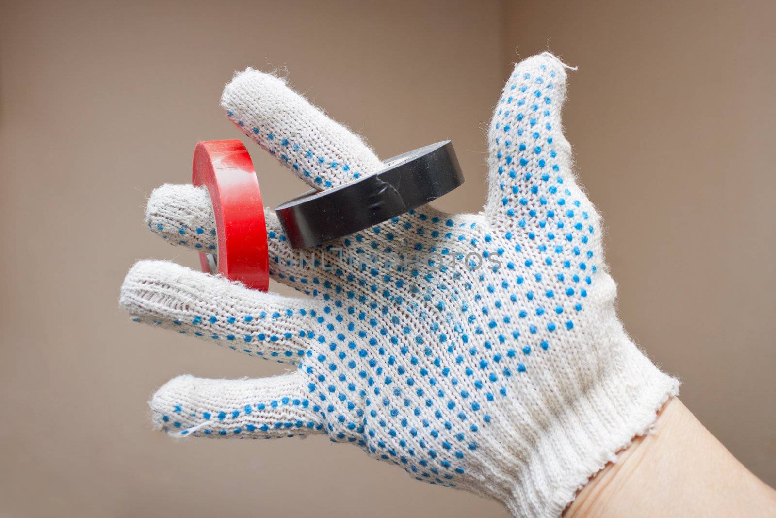Hand in a glove and an insulating tape