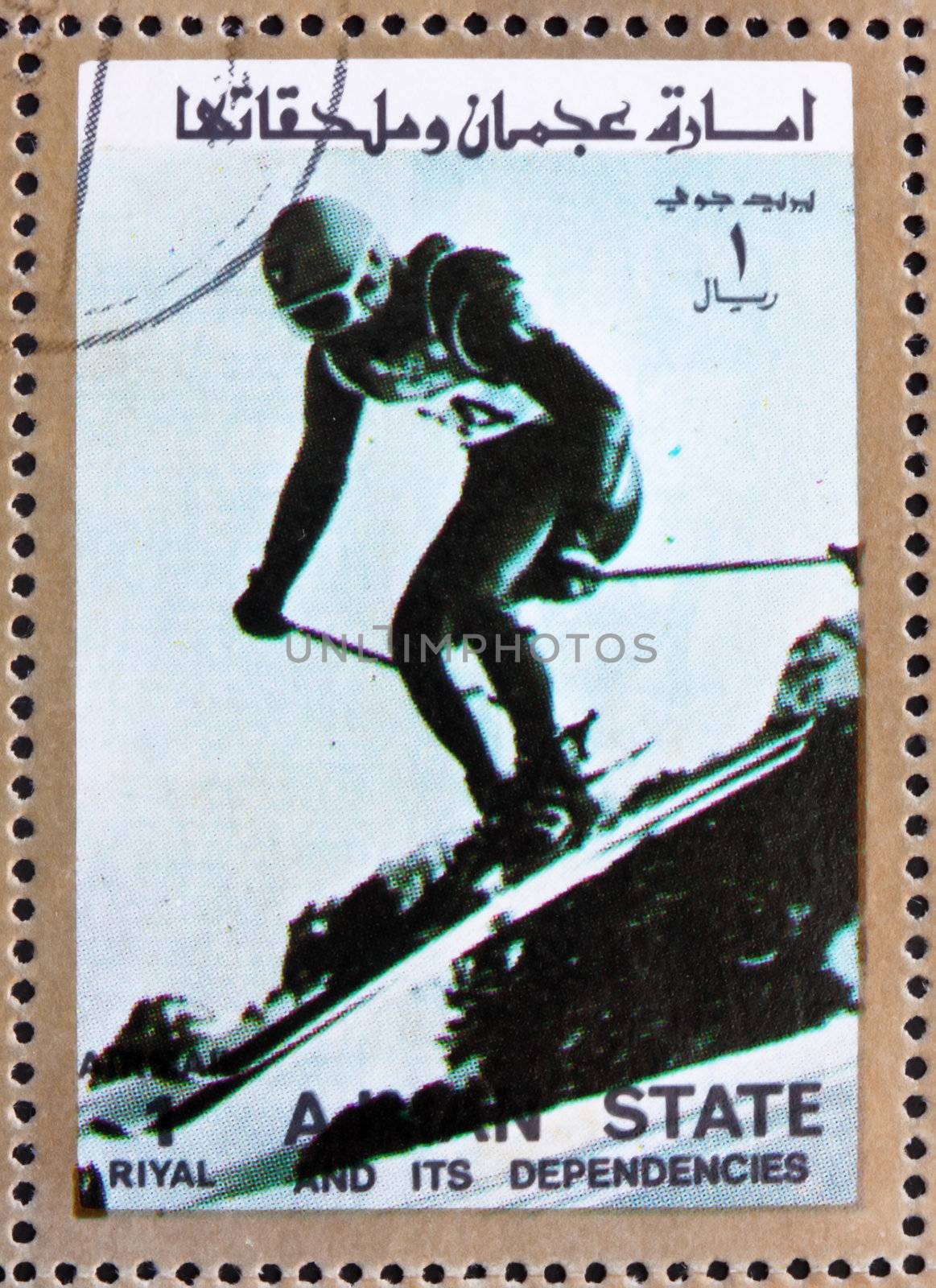 AJMAN - CIRCA 1973: a stamp printed in the Ajman shows Downhill Skiing, Alpine Skiing, Winter Olympics, circa 1973