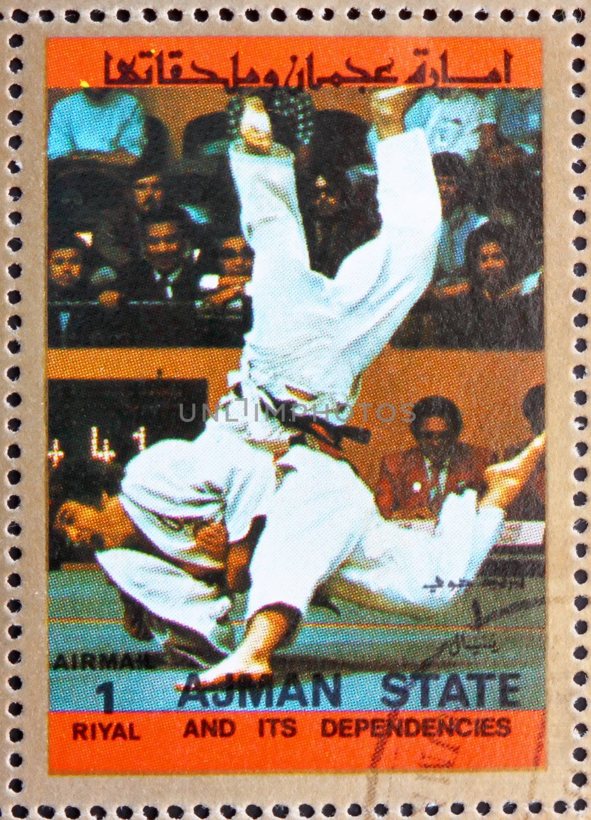AJMAN - CIRCA 1973: a stamp printed in the Ajman shows Judo, Olympic sports, circa 1973