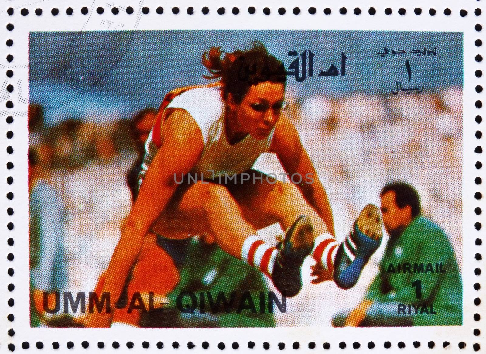 UMM AL-QUWAIN - CIRCA 1972: a stamp printed in the Umm al-Quwain shows Long Jump, Athletics, Summer Olympics, Munich 1972, circa 1972
