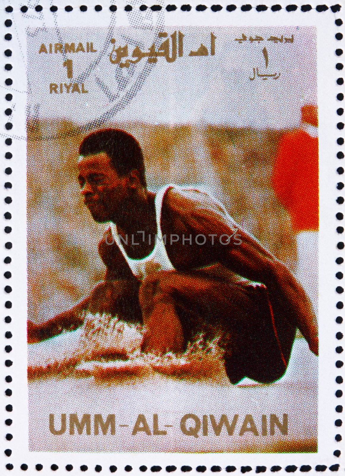 UMM AL-QUWAIN - CIRCA 1972: a stamp printed in the Umm al-Quwain shows Long Jump, Athletics, Summer Olympics, Munich 1972, circa 1972