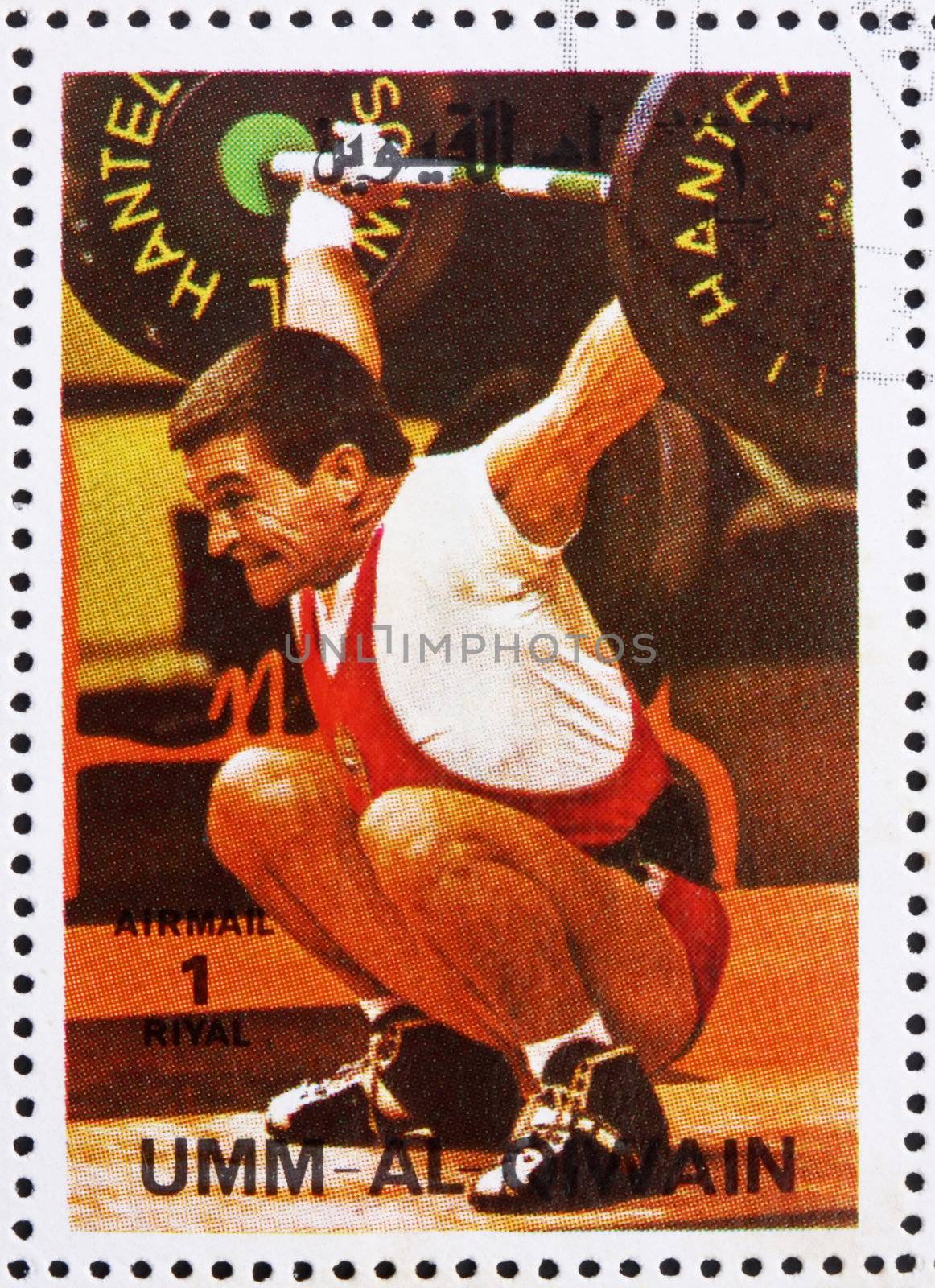 UMM AL-QUWAIN - CIRCA 1972: a stamp printed in the Umm al-Quwain shows Weightlifting, Gymnastics, Summer Olympics, Munich 1972, circa 1972