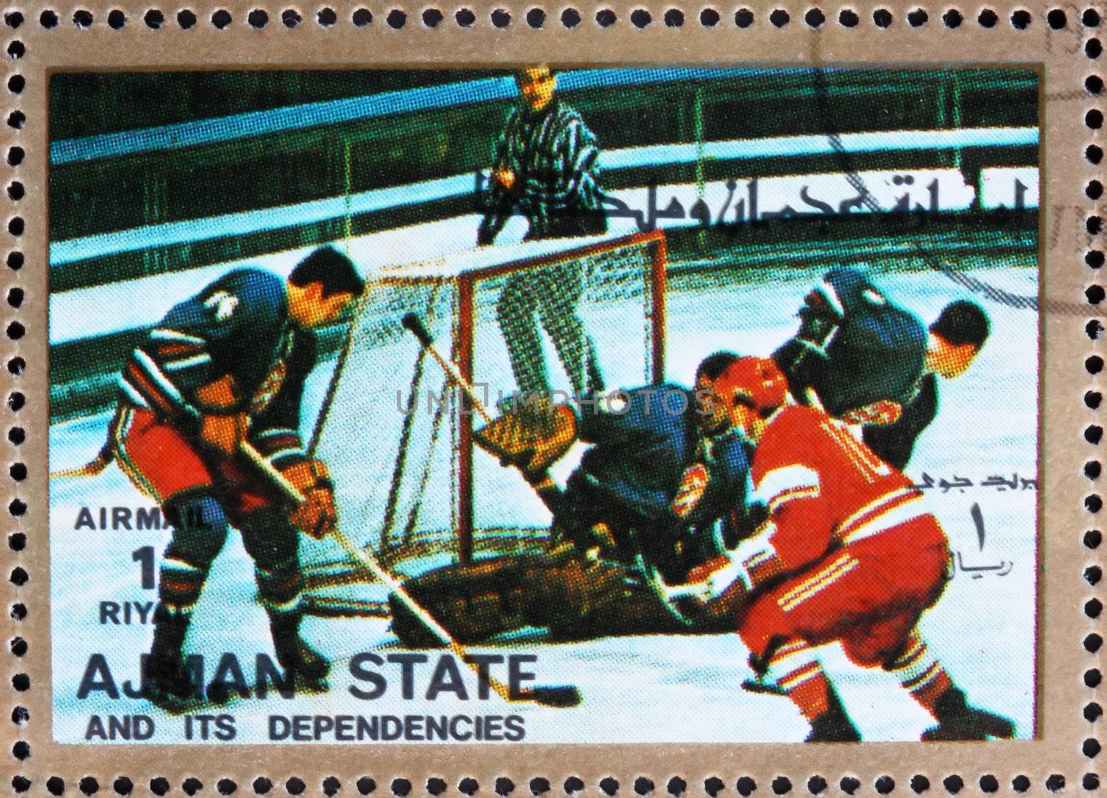 AJMAN - CIRCA 1973: a stamp printed in the Ajman shows Ice Hockey, Winter Olympics, circa 1973