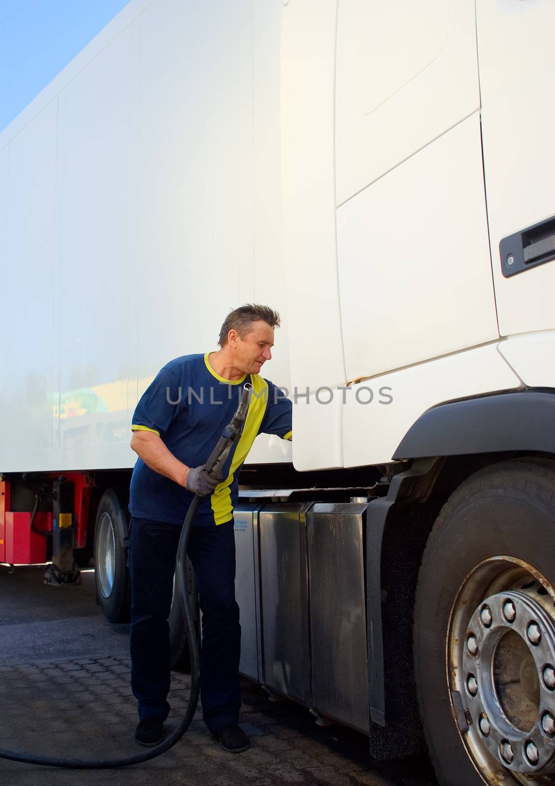 Driver at the gas station run by the truck