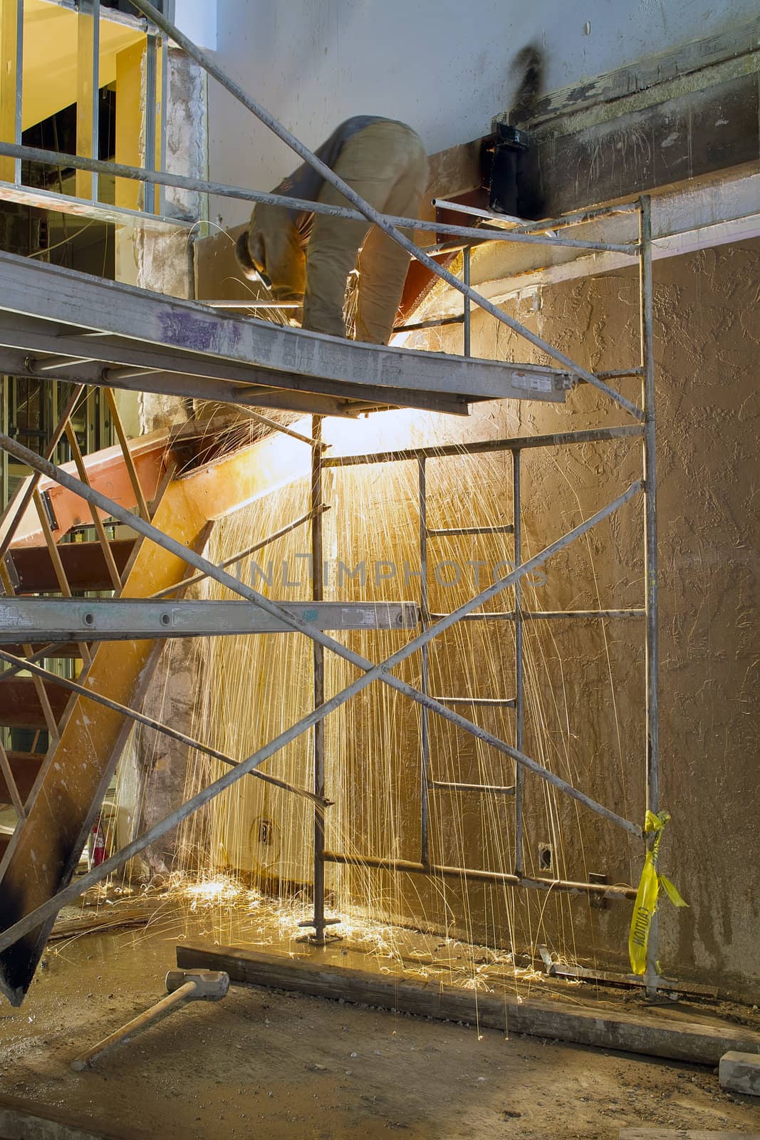 Construction Worker with Blow Torch Welding and Cutting Steel Staircase