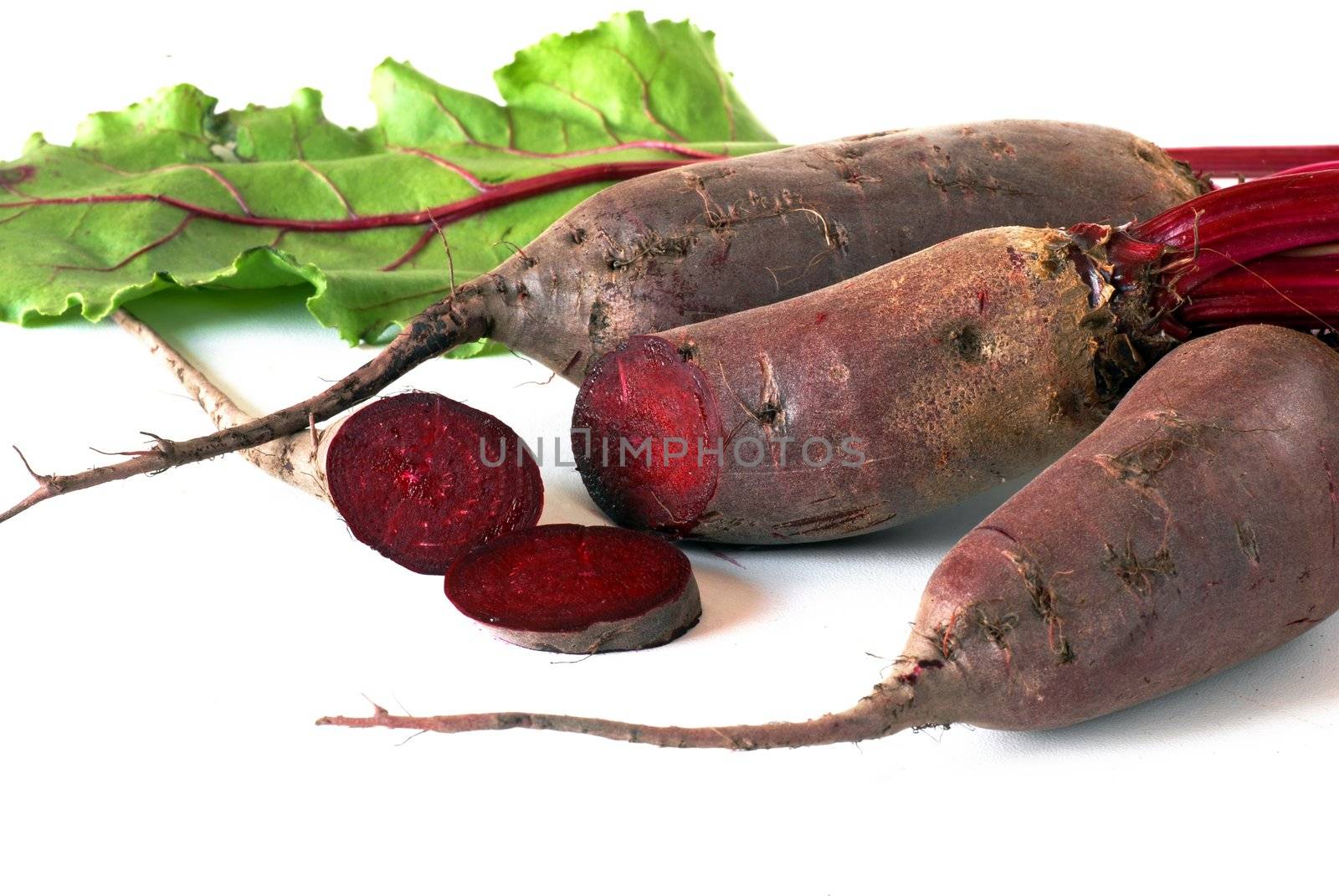 bunch of raw beet roots over white background