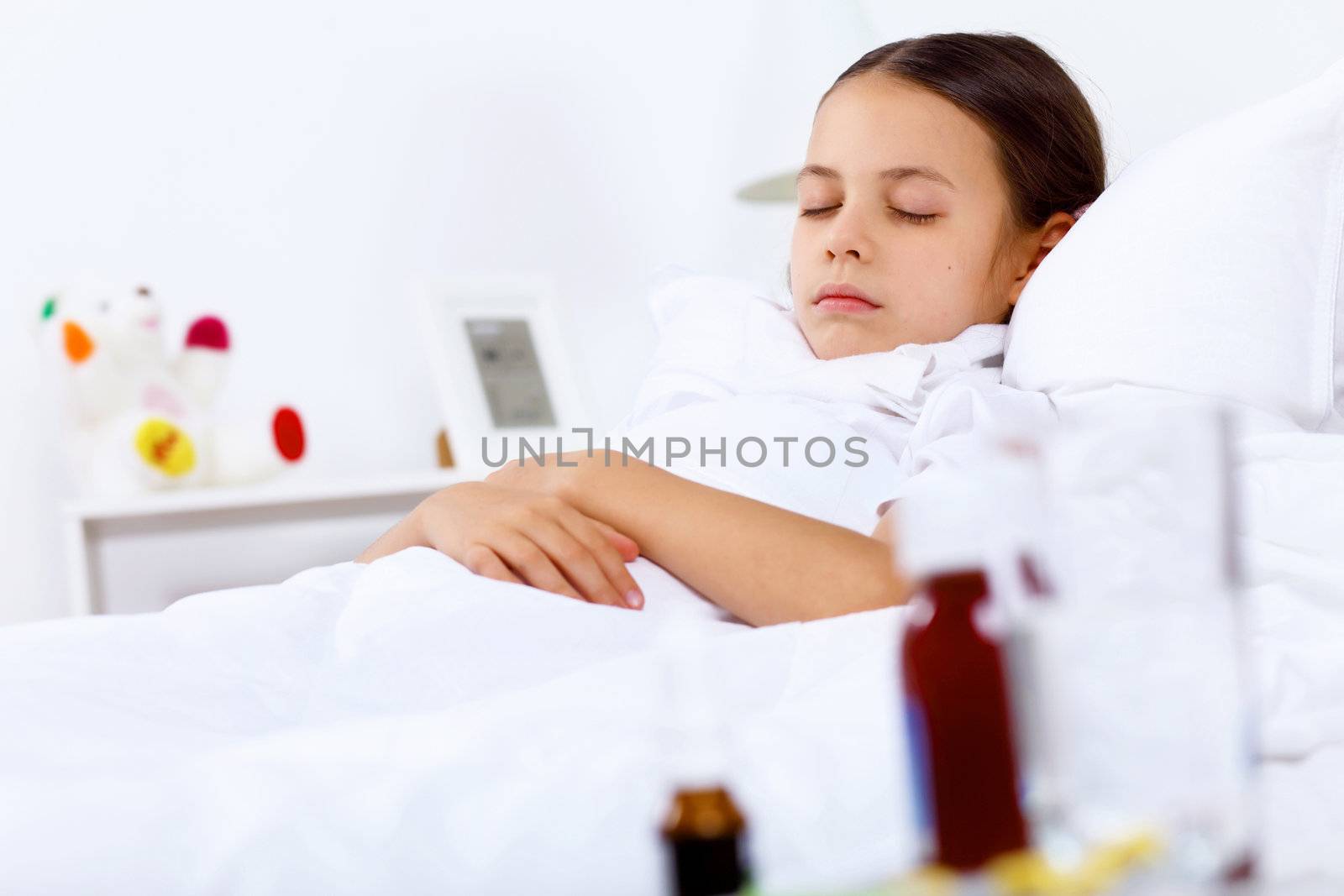 Little girl with illness at bed at home