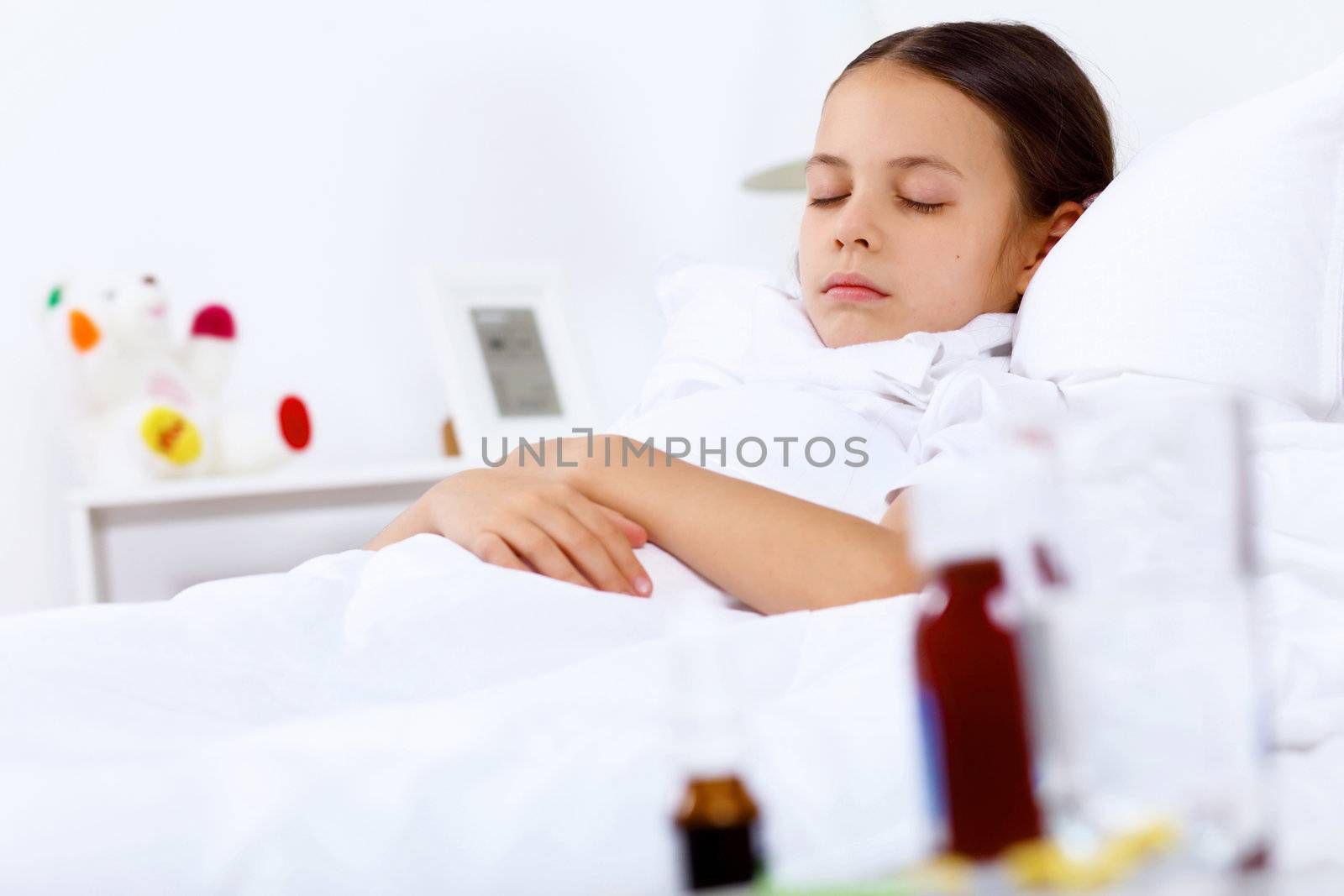 Little girl with illness at bed at home