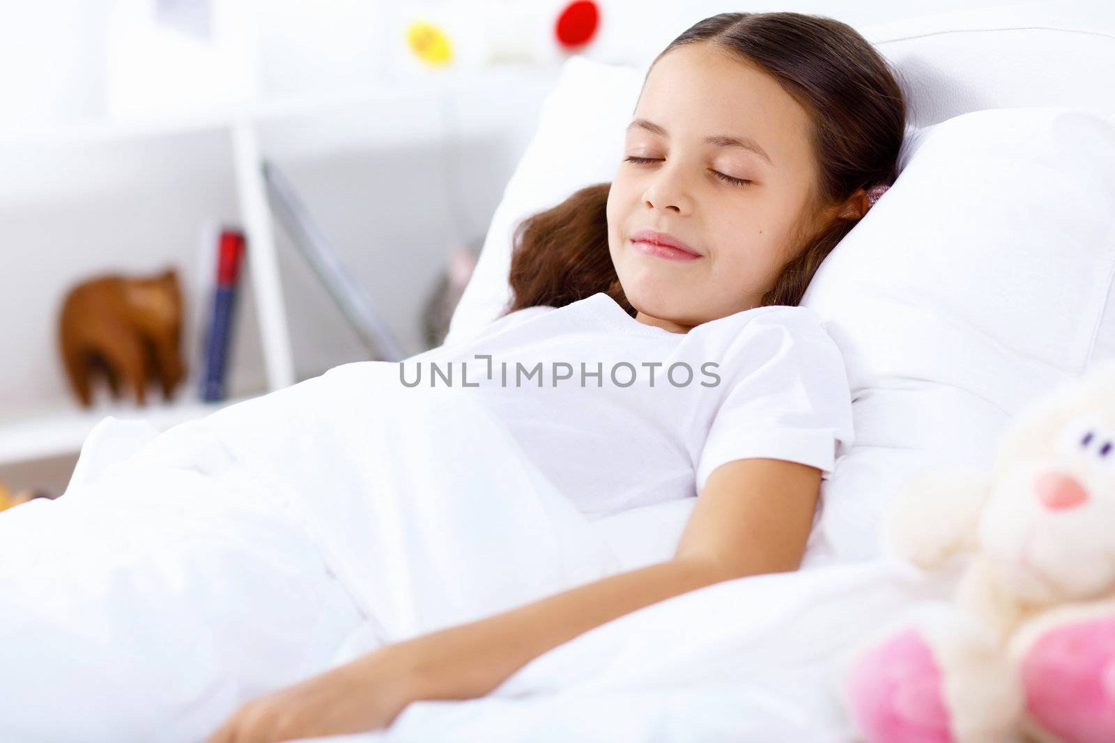 Little girl sleepng in her bed at home