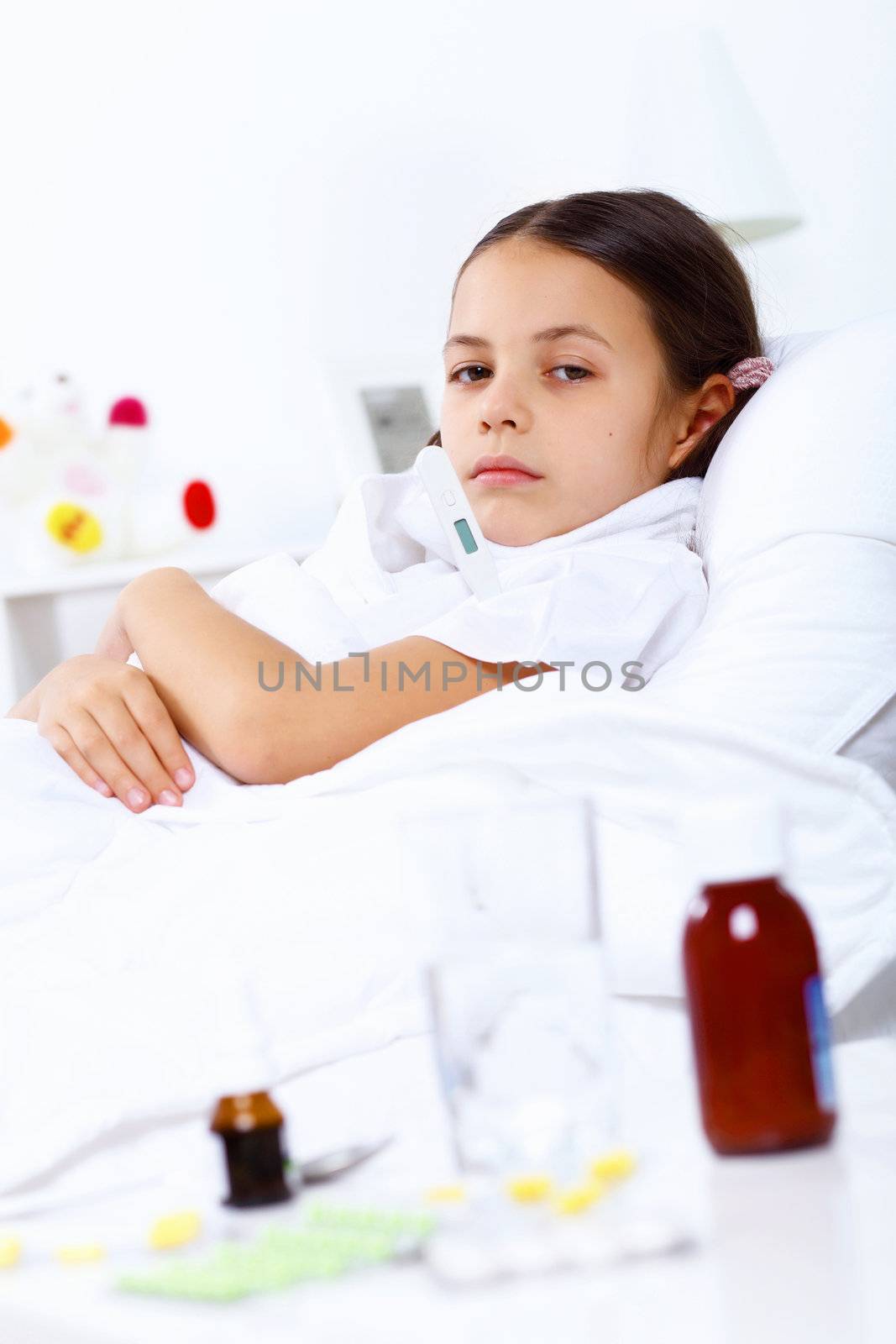 Little girl with illness at bed at home