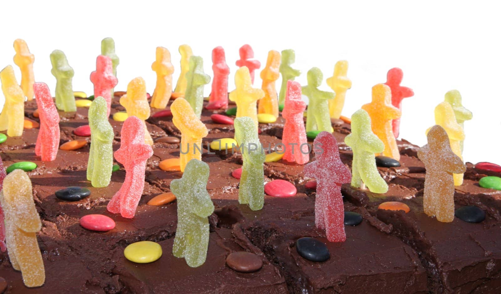Chocolate cake with jelly men isolated on white by sundaune