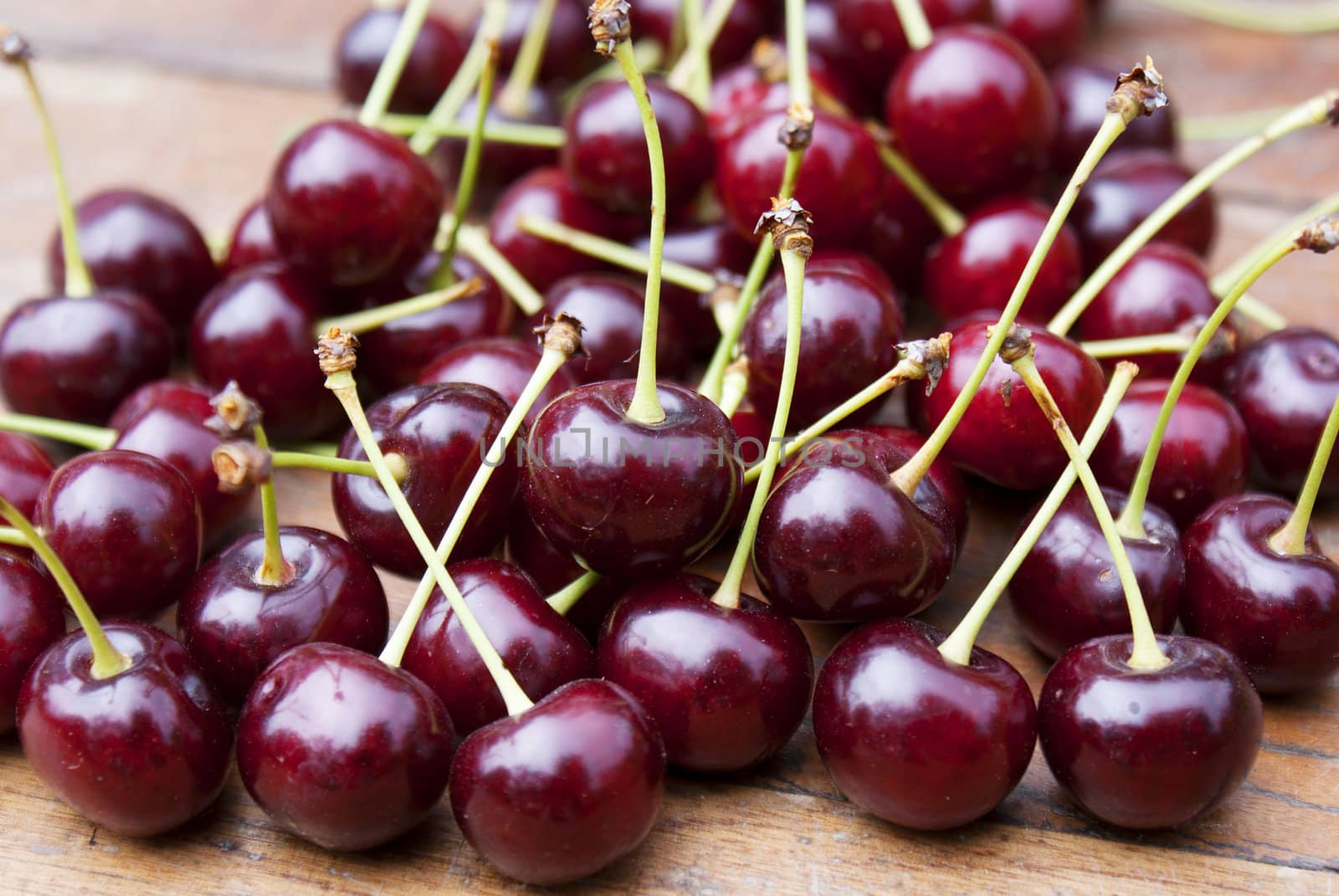 Ripe fresh berries of a cherry on an old wooden table