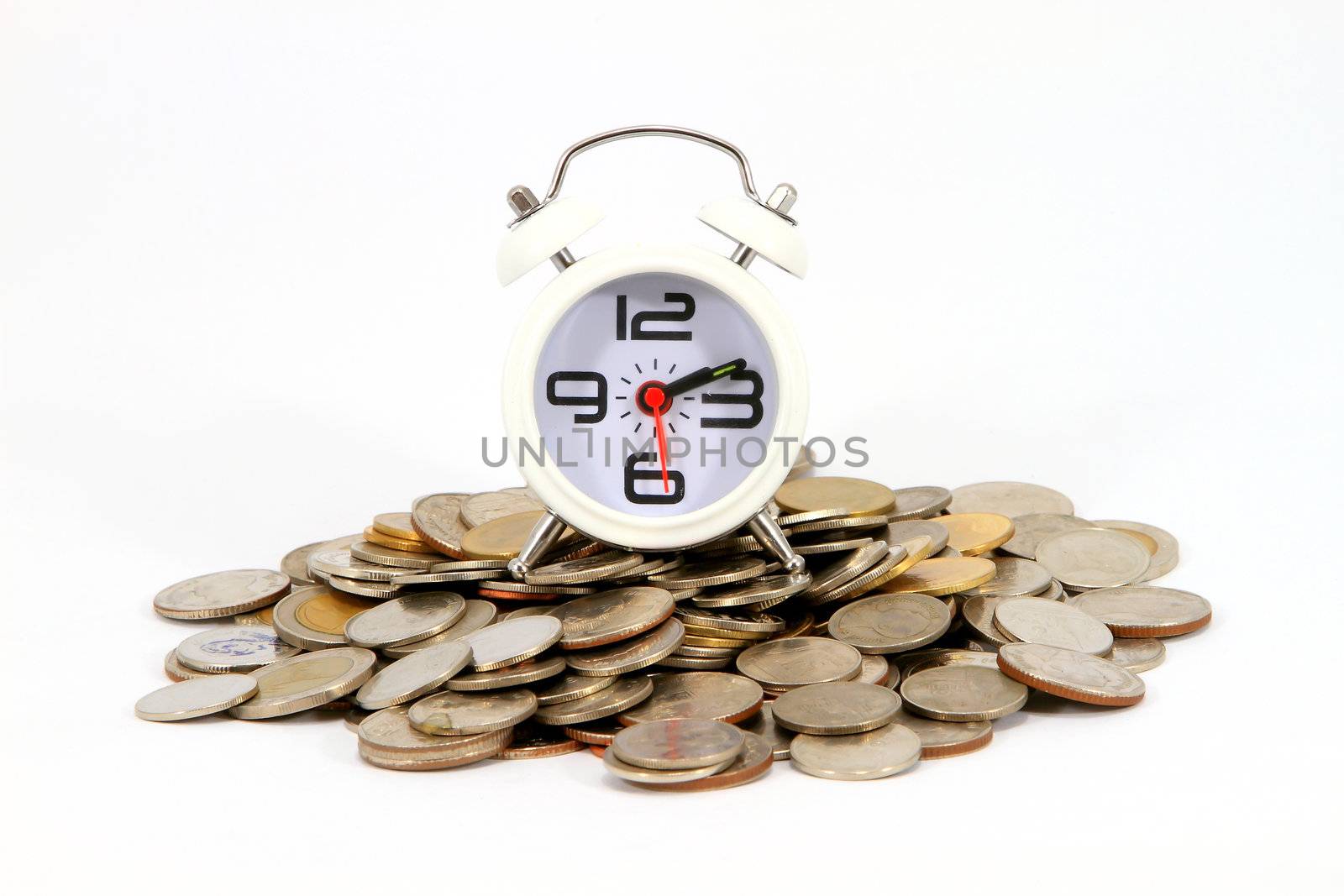Beautiful old clock staying on one  coins. Time is money concept