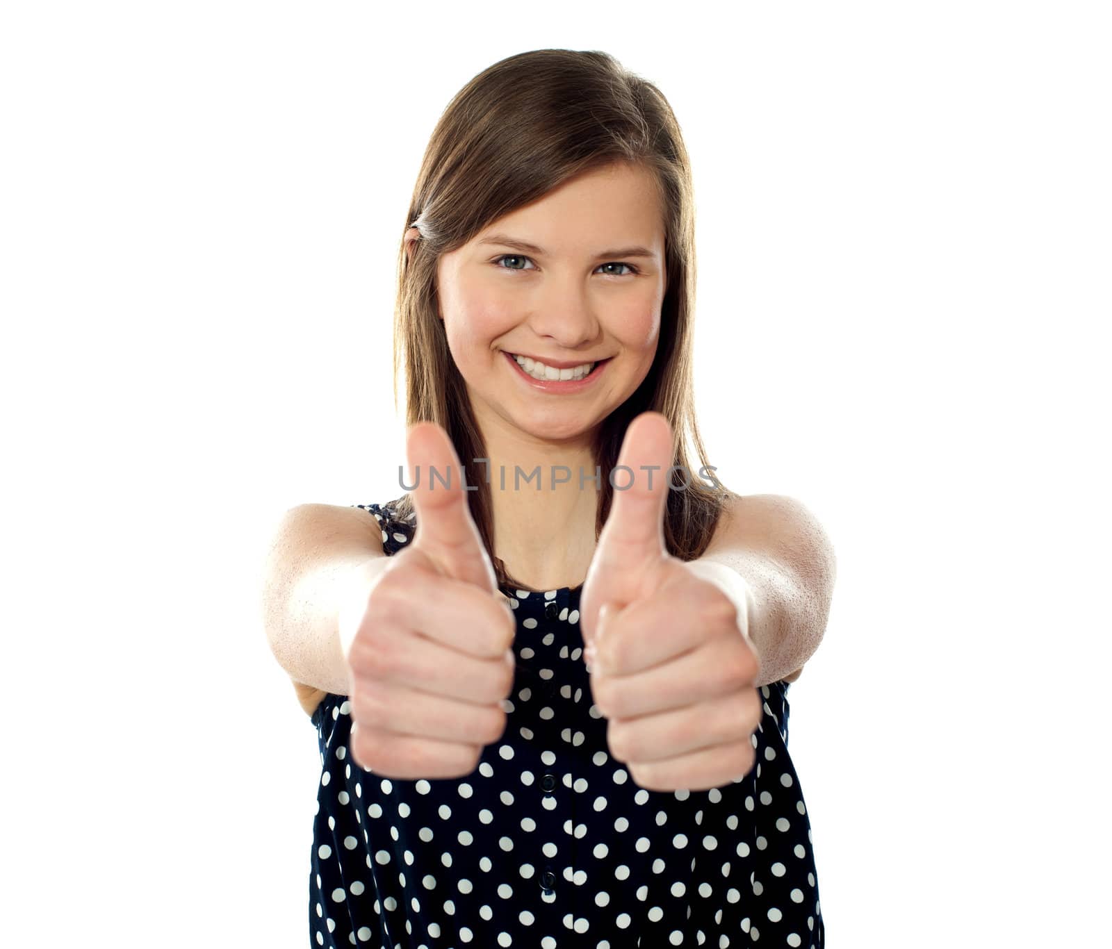 Close view of a pretty teenager showing double thumbs up