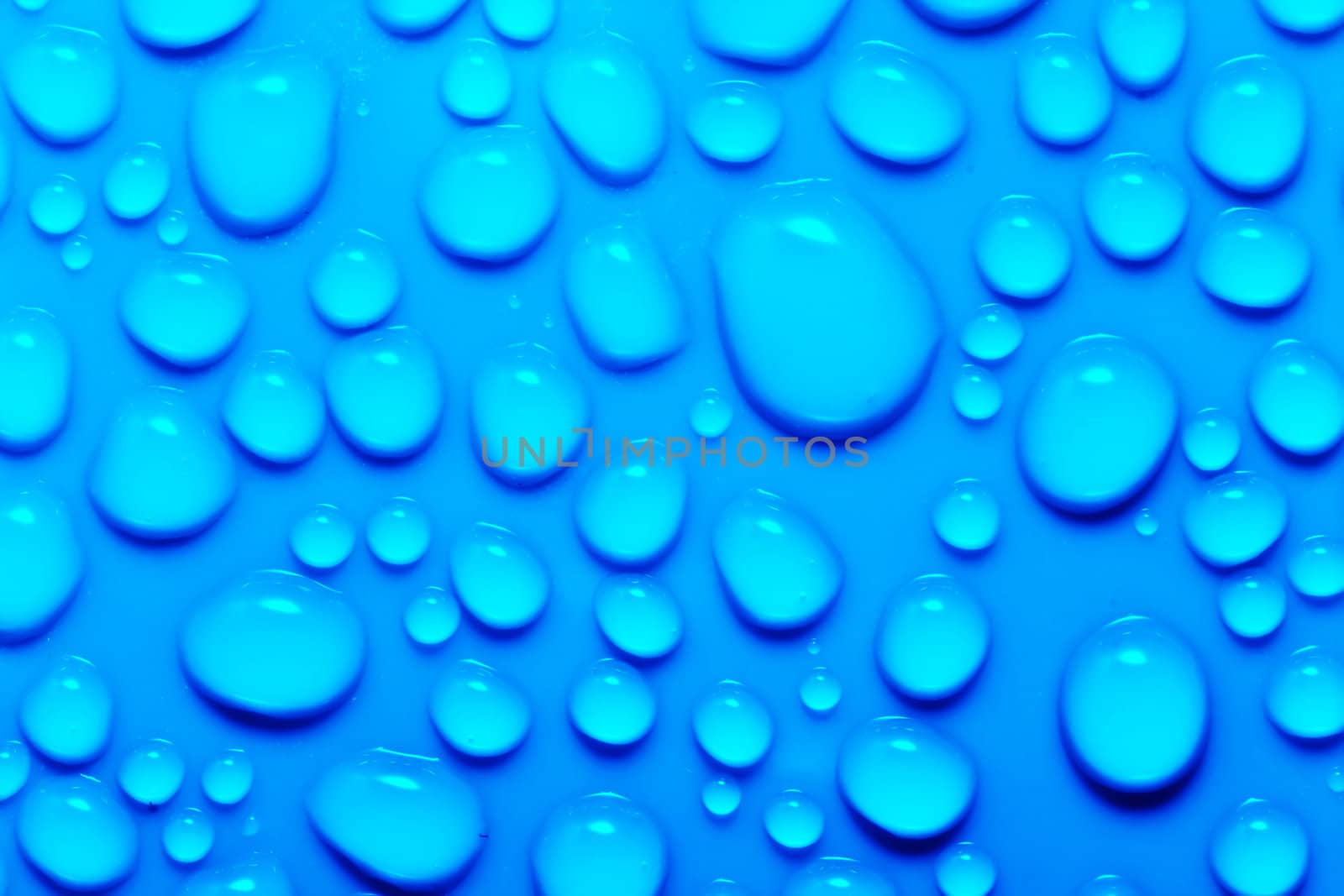 Water drops on a green surface