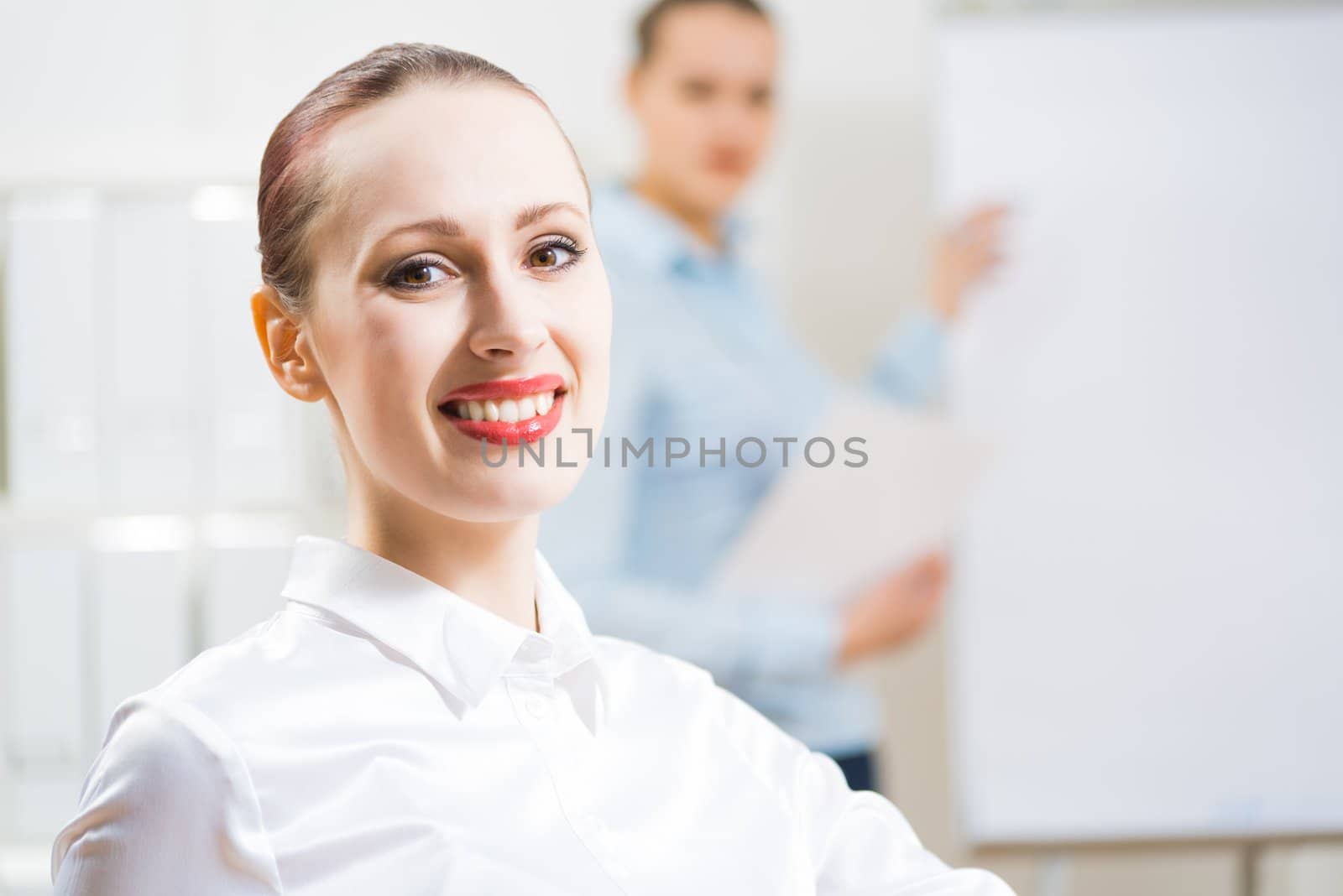 portrait of a business woman in office, smiling and looking into the camera, office work